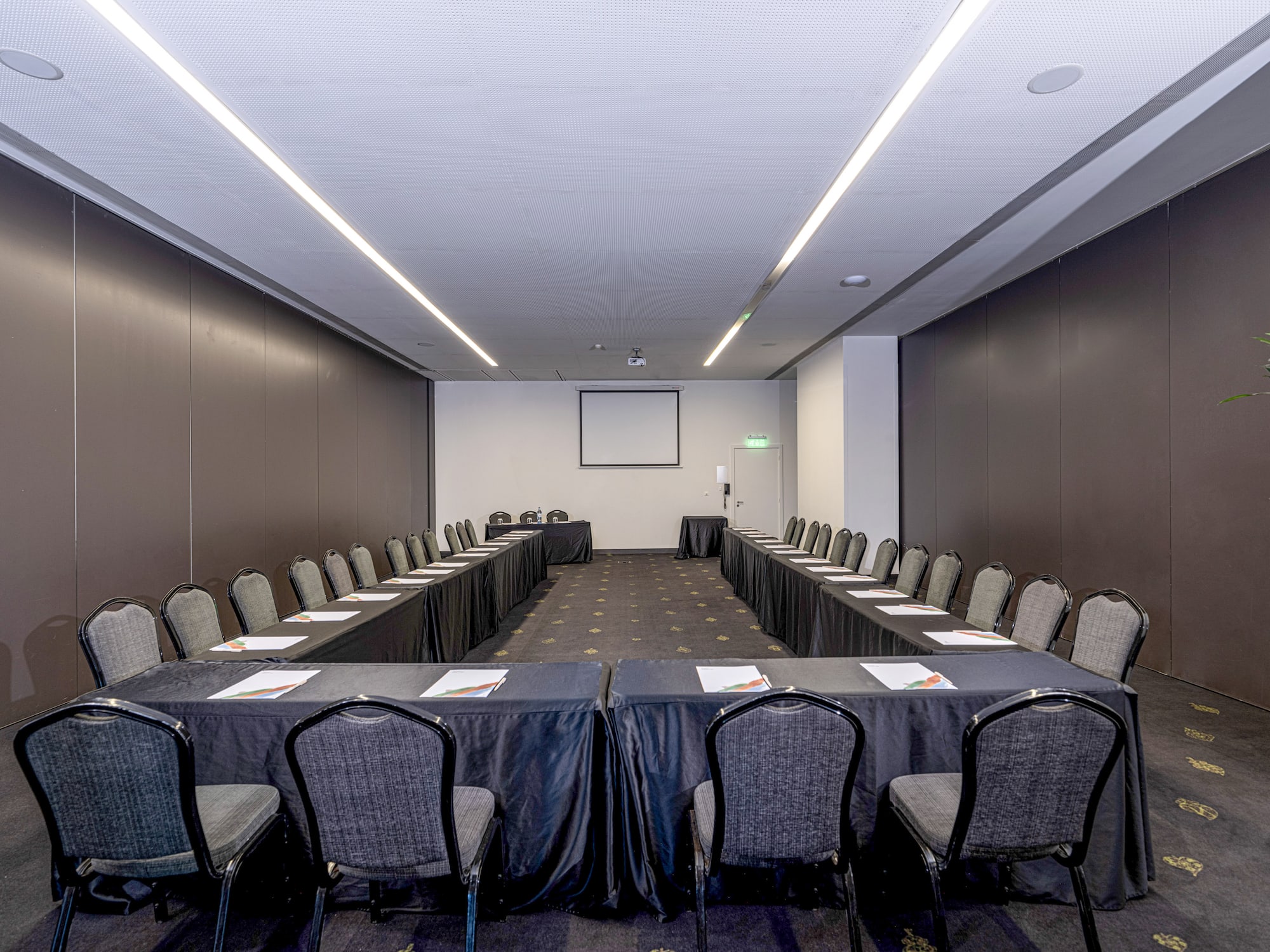 a room with a long table and chairs