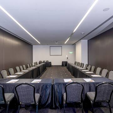 a room with a long table and chairs