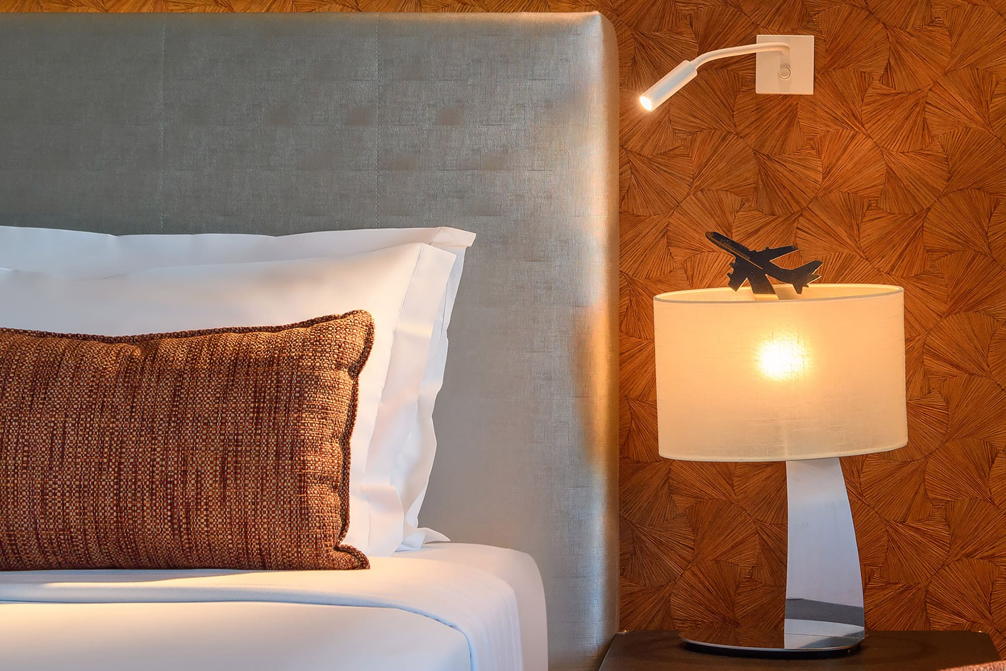 a bed with a lamp and a table