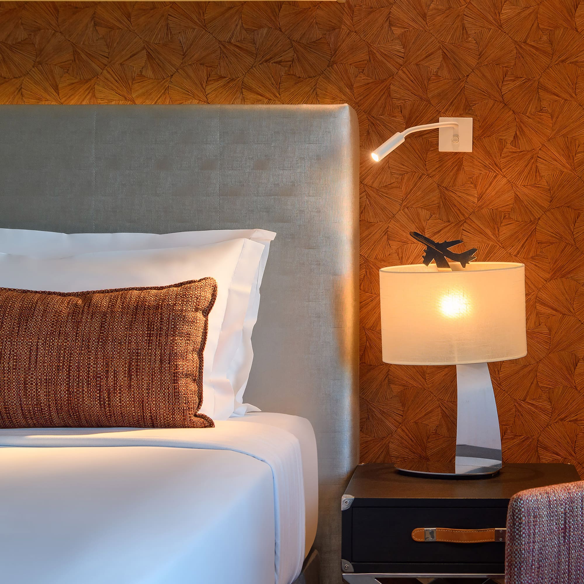 a bed with a lamp and a table