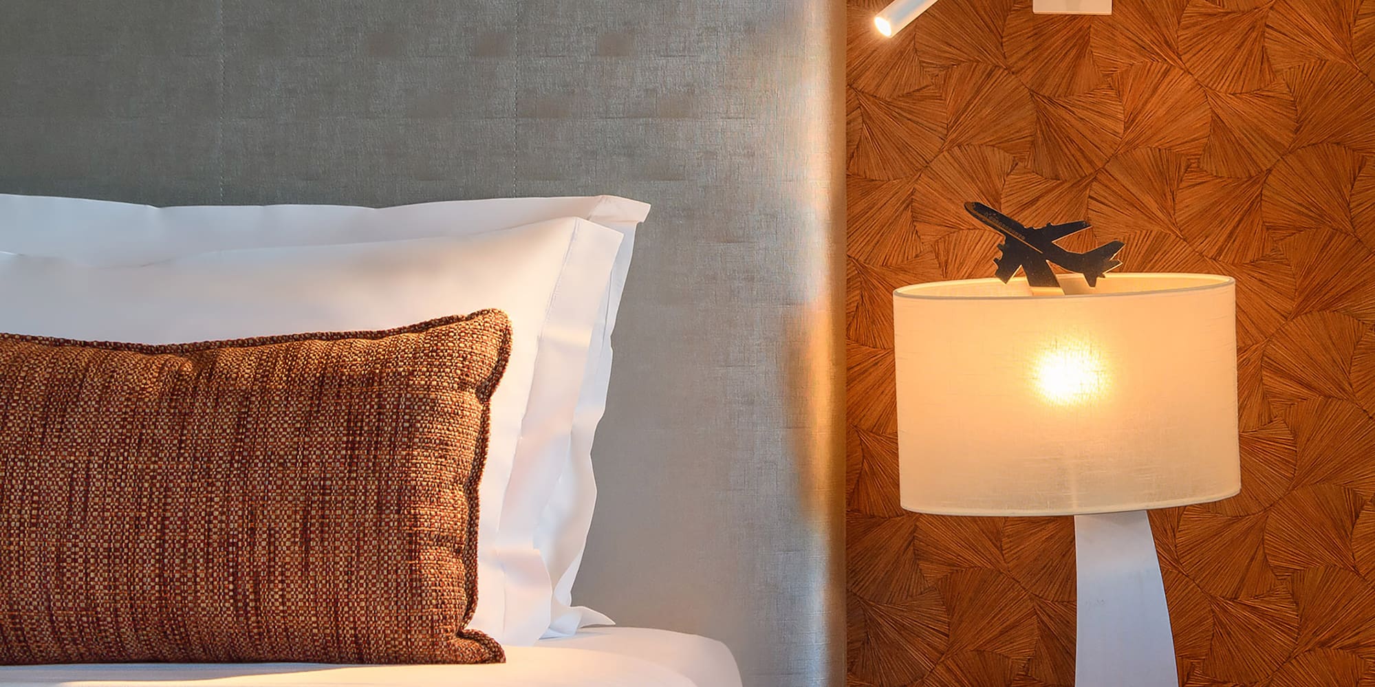 a bed with a lamp and a table