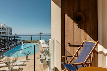 a deck chair next to a pool