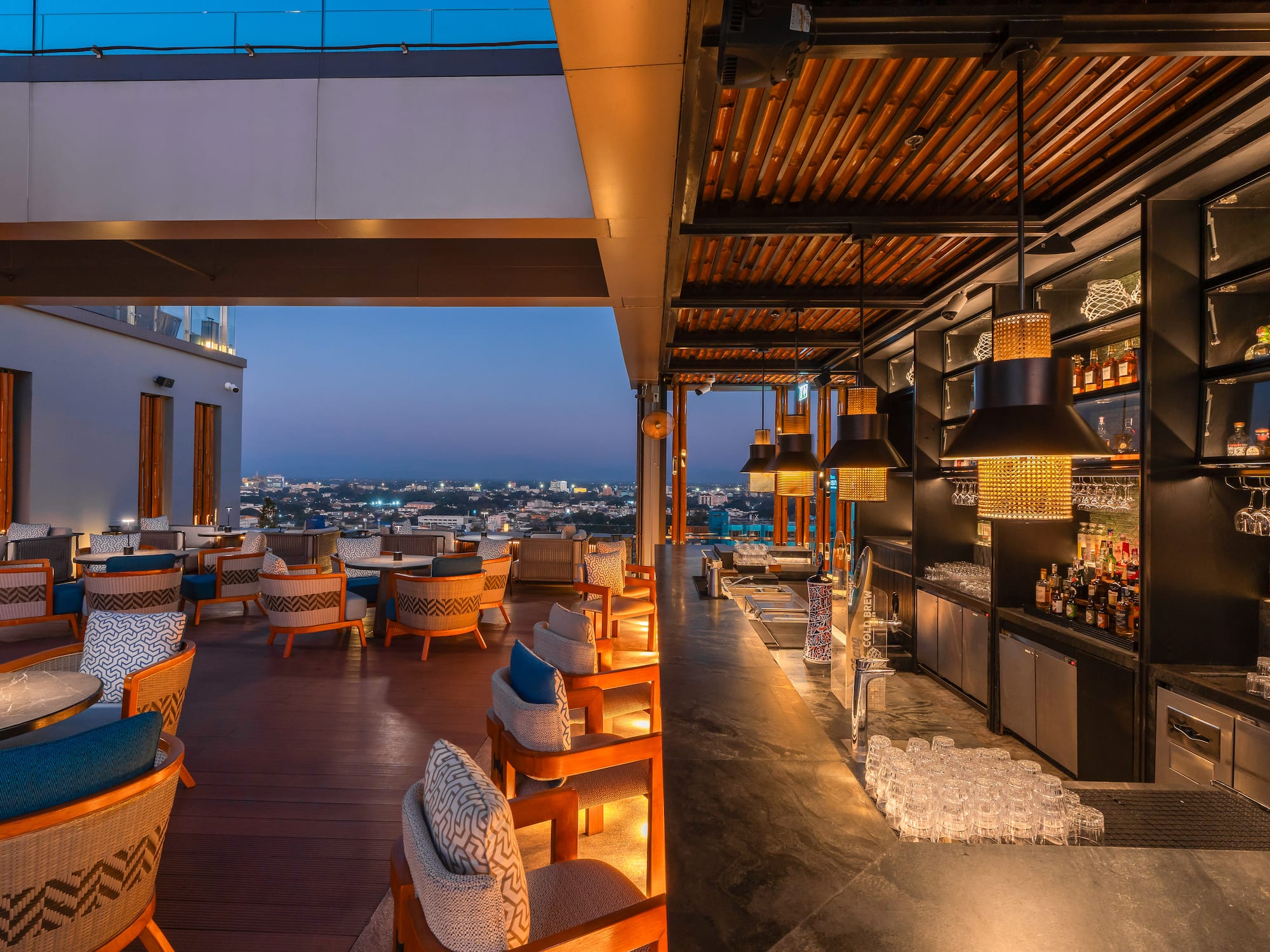 a restaurant with chairs and drinks on the roof