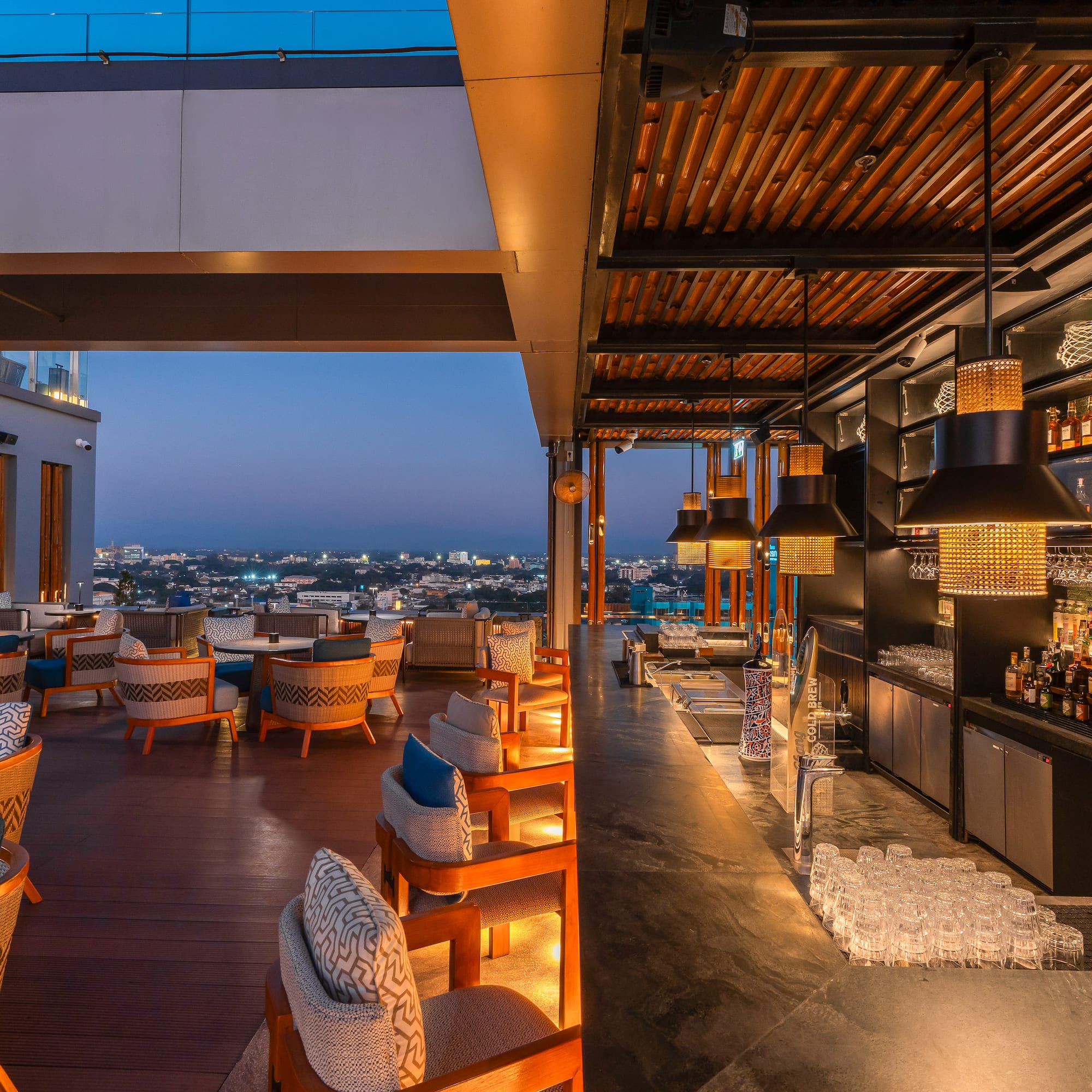 a restaurant with chairs and drinks on the roof