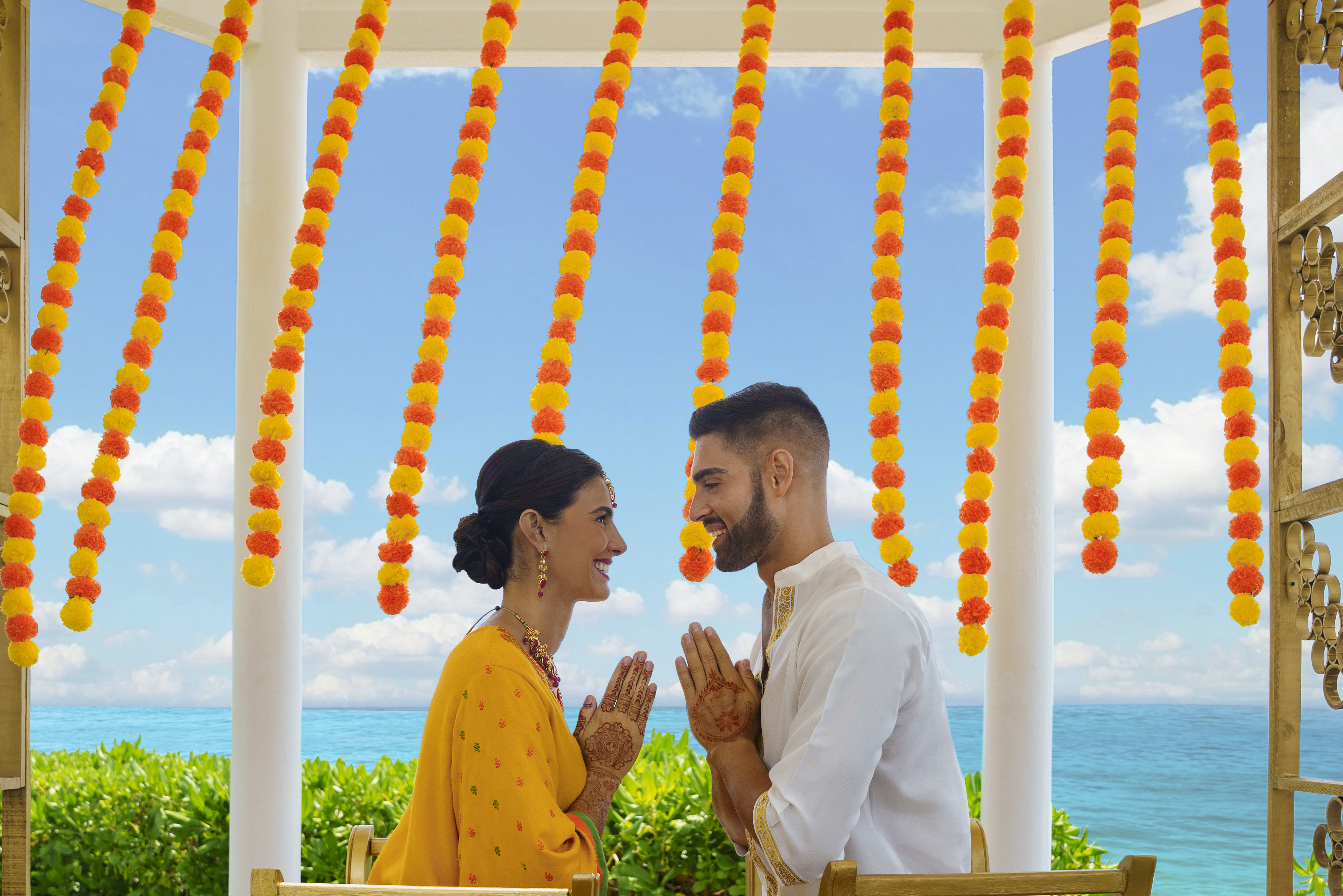 a man and woman in traditional attire holding hands together