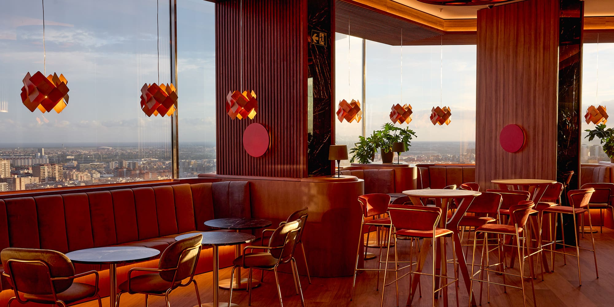 a room with tables and chairs and a view of a city
