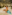 Happy mom and daughter on a surfboard at a tropical beach.