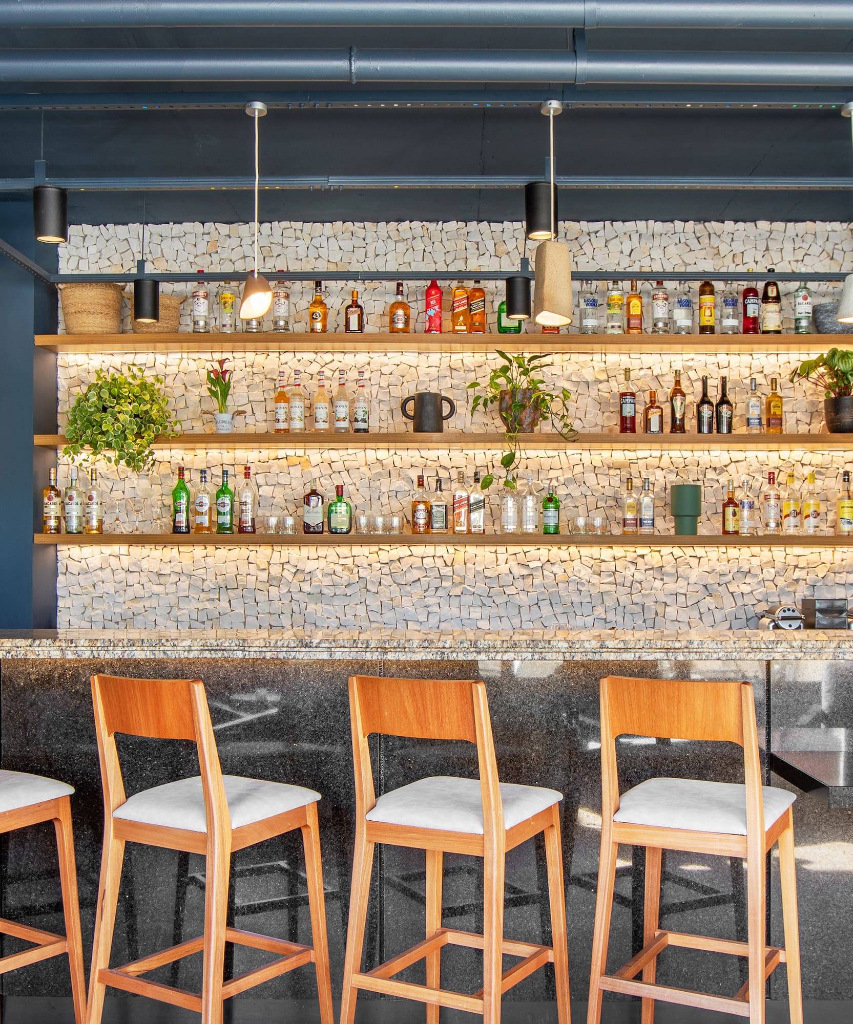 a bar with chairs and shelves