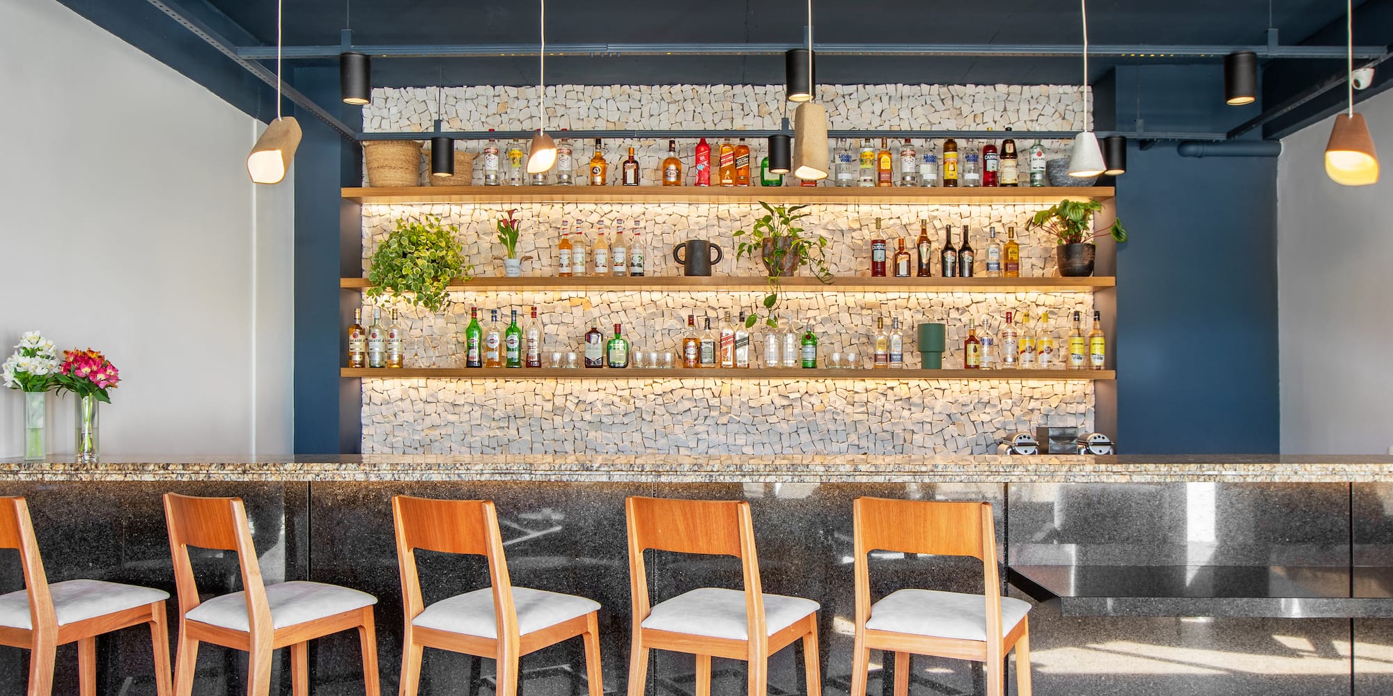 a bar with chairs and shelves