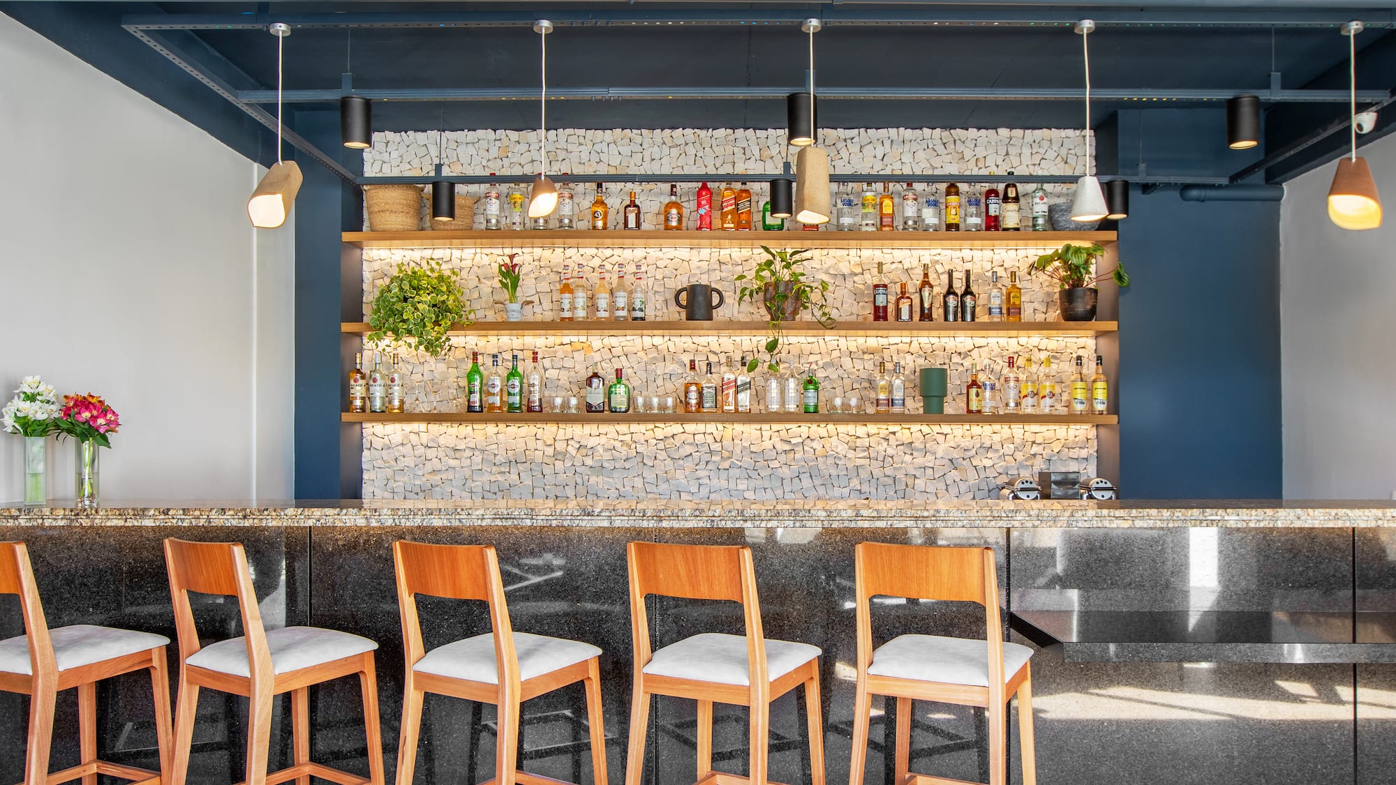 a bar with chairs and shelves