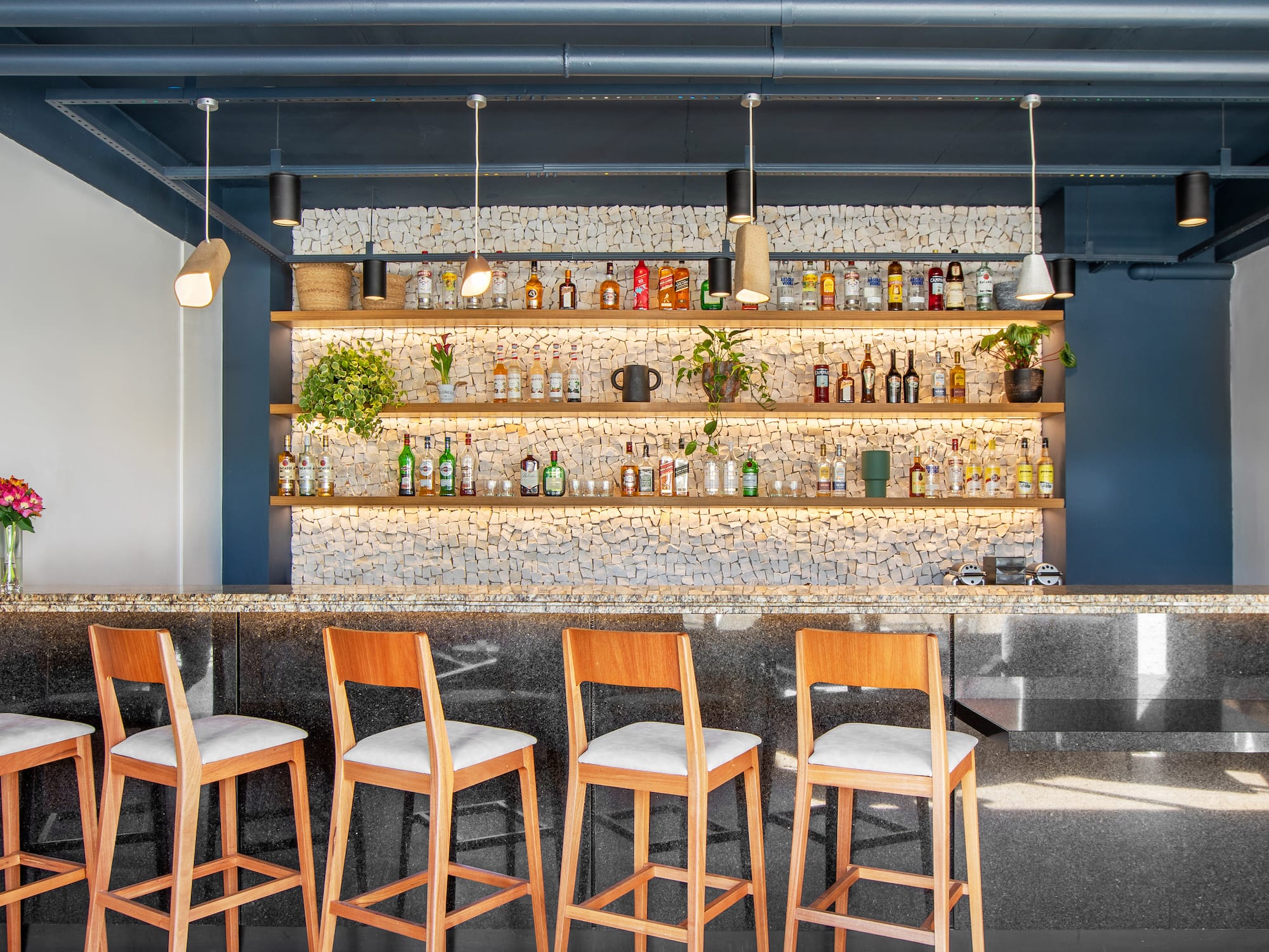 a bar with chairs and shelves