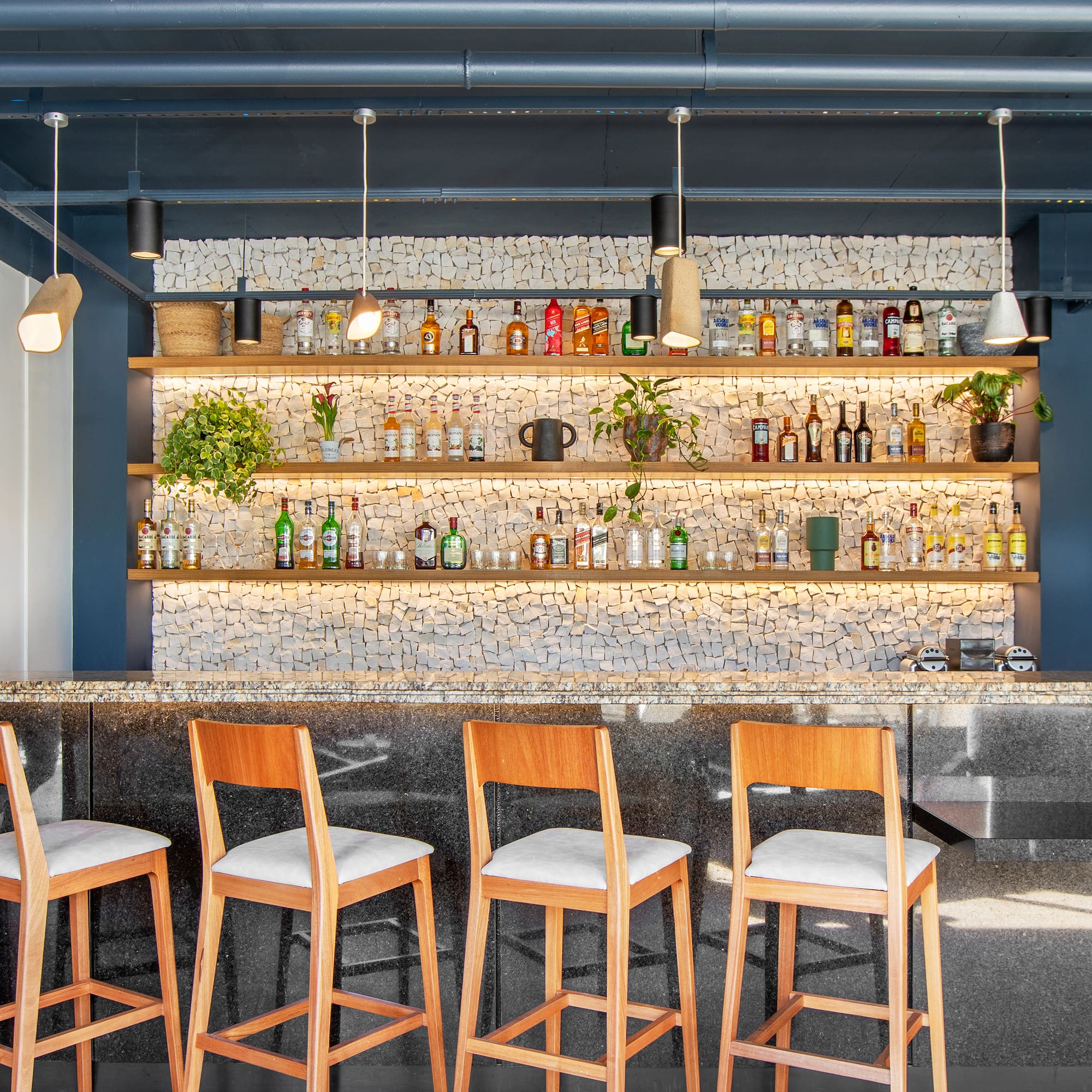 a bar with chairs and shelves