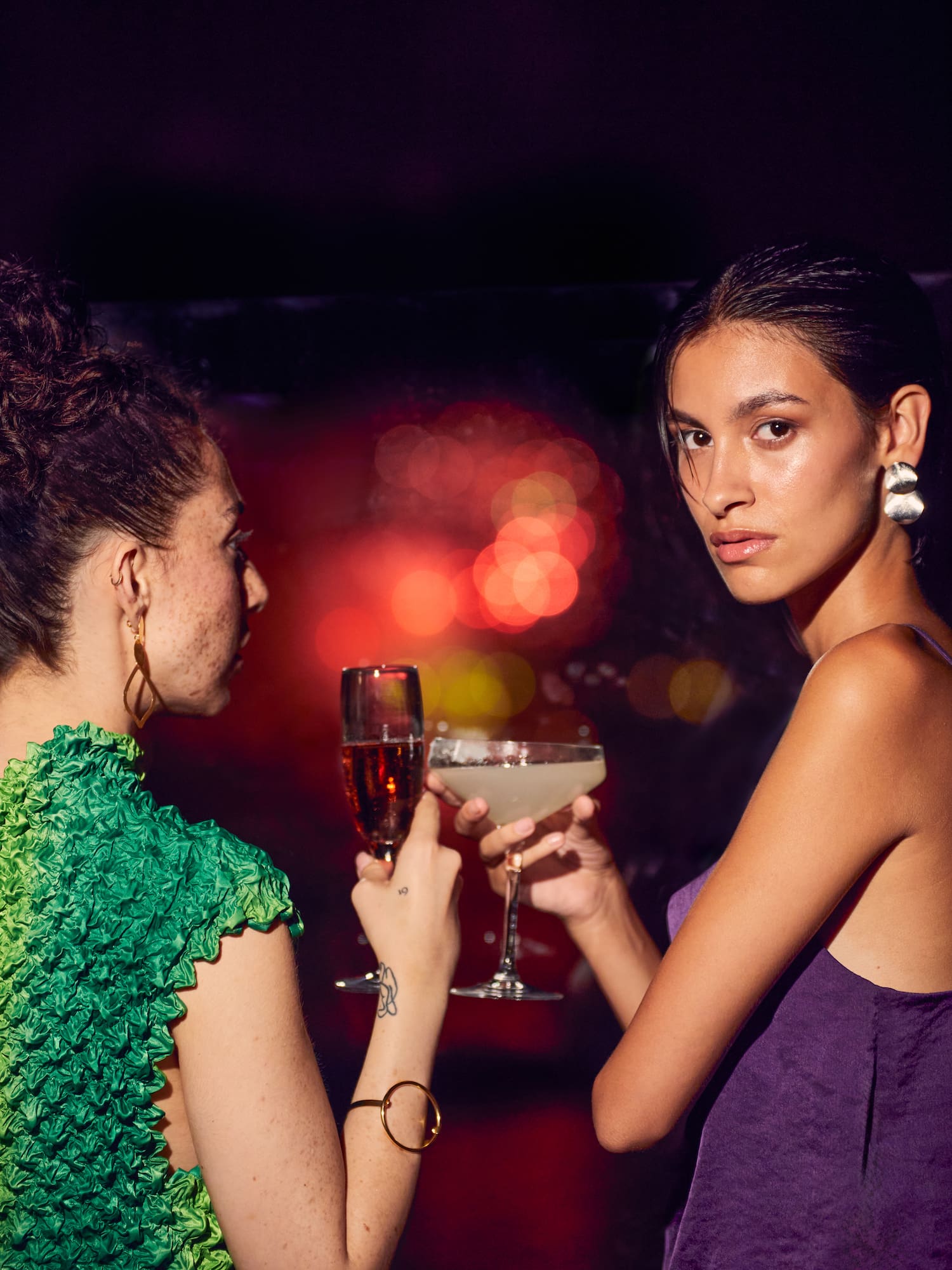 two women holding drinks