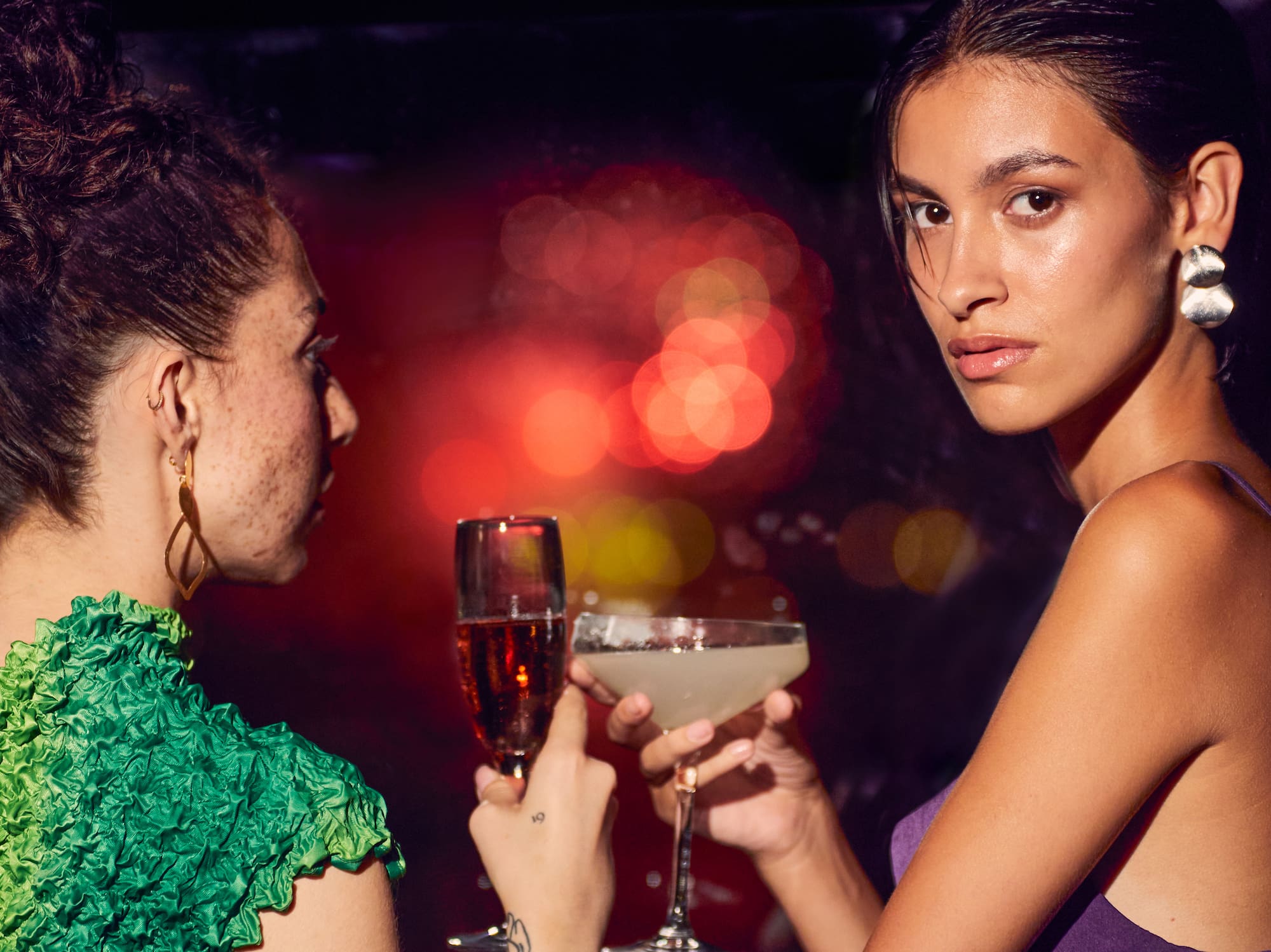 two women holding drinks