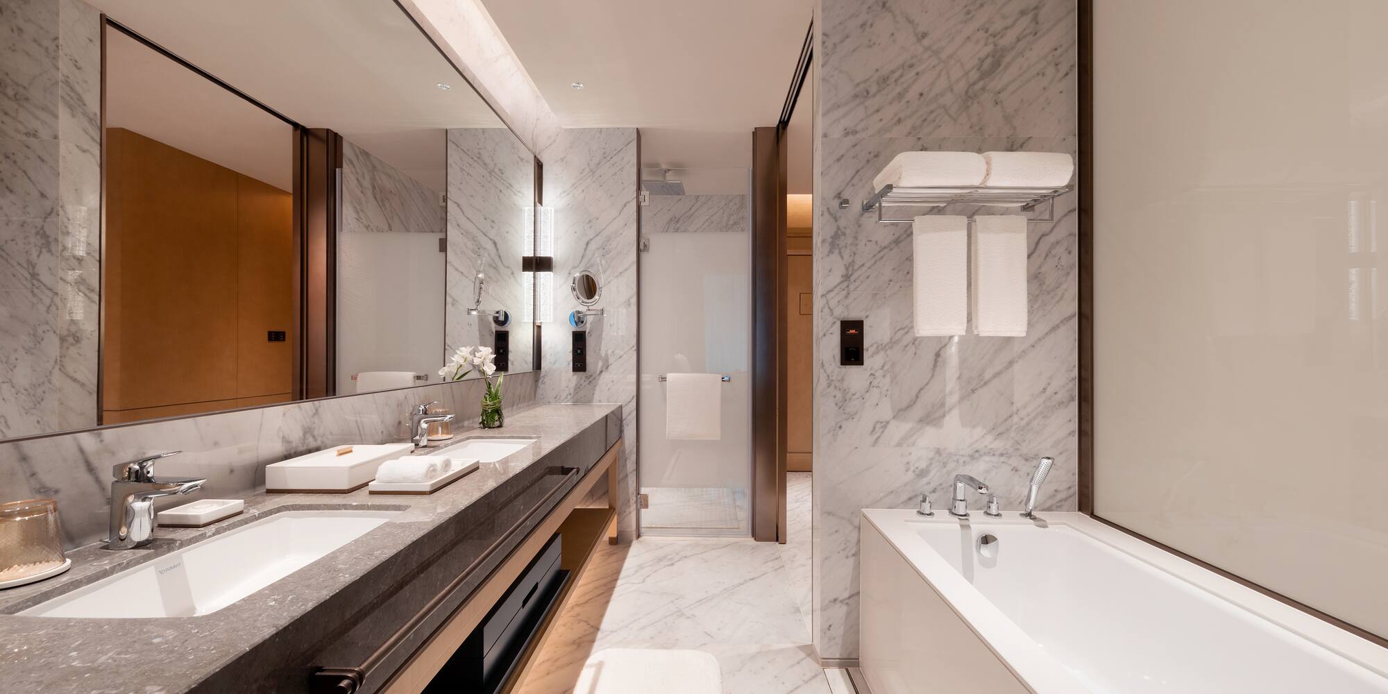 a bathroom with marble walls and a bathtub