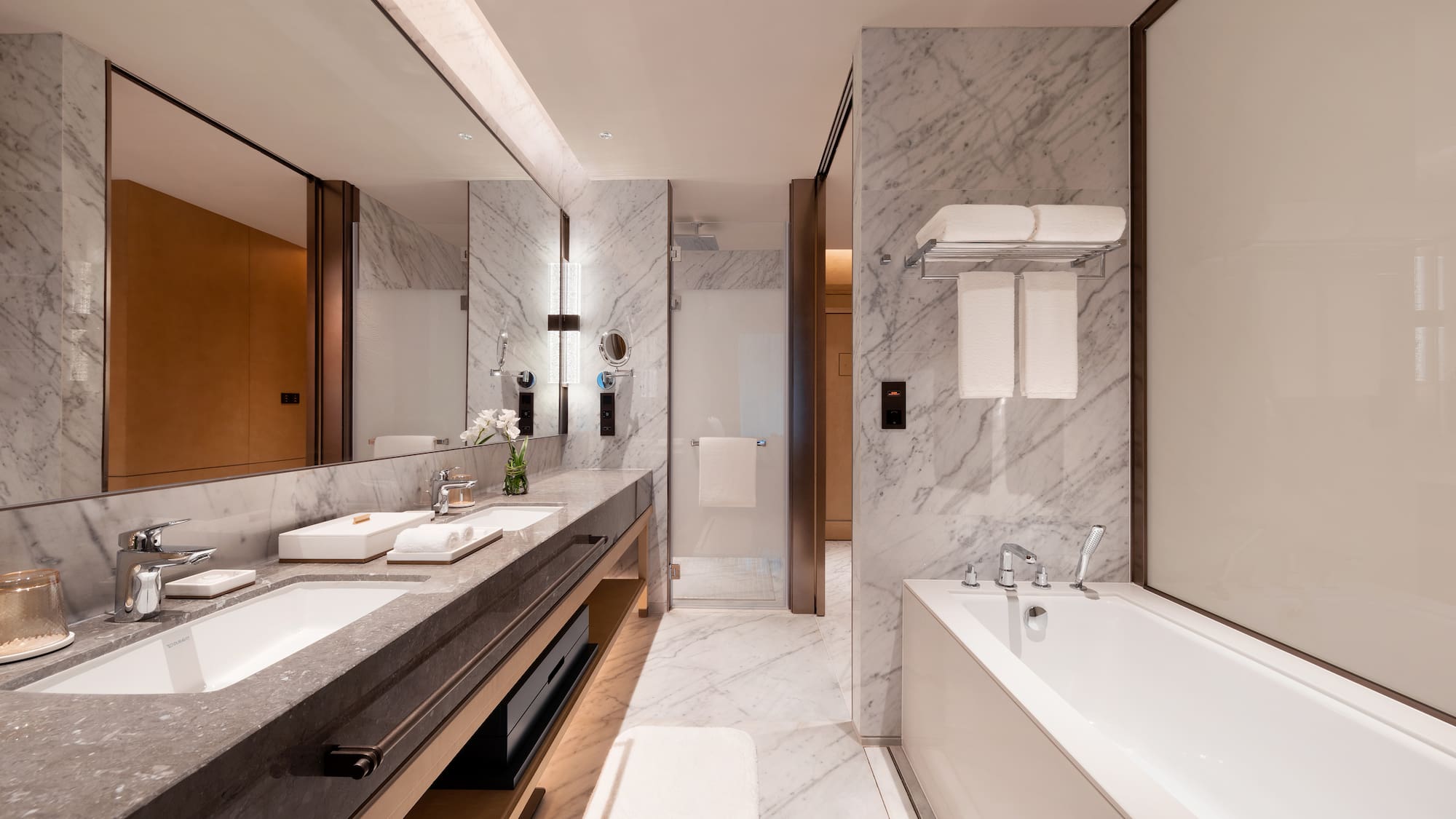 a bathroom with marble walls and a bathtub