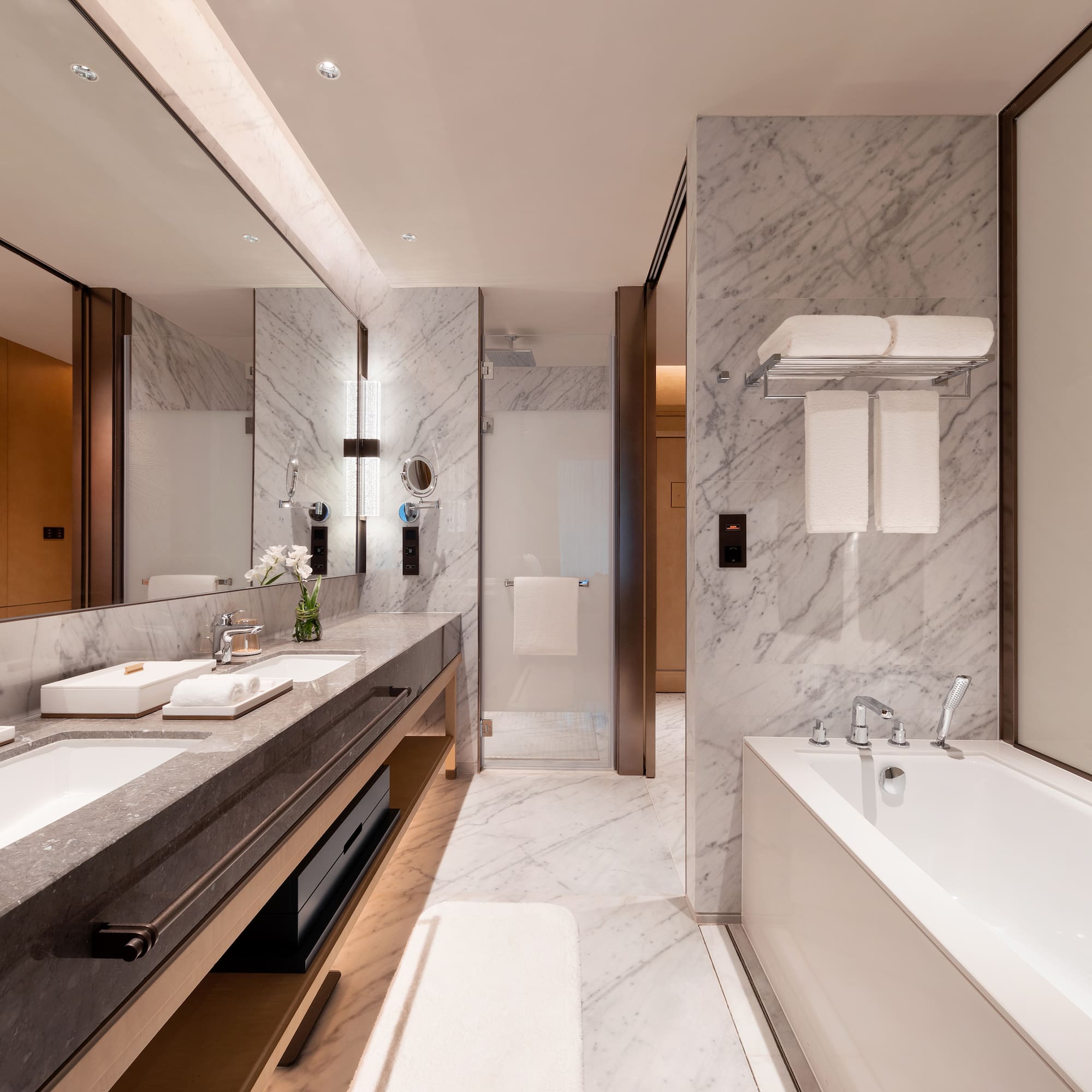 a bathroom with marble walls and a bathtub