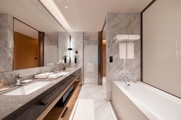a bathroom with marble walls and a bathtub