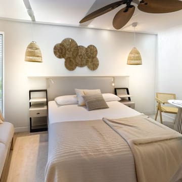 a room with a bed and a fan