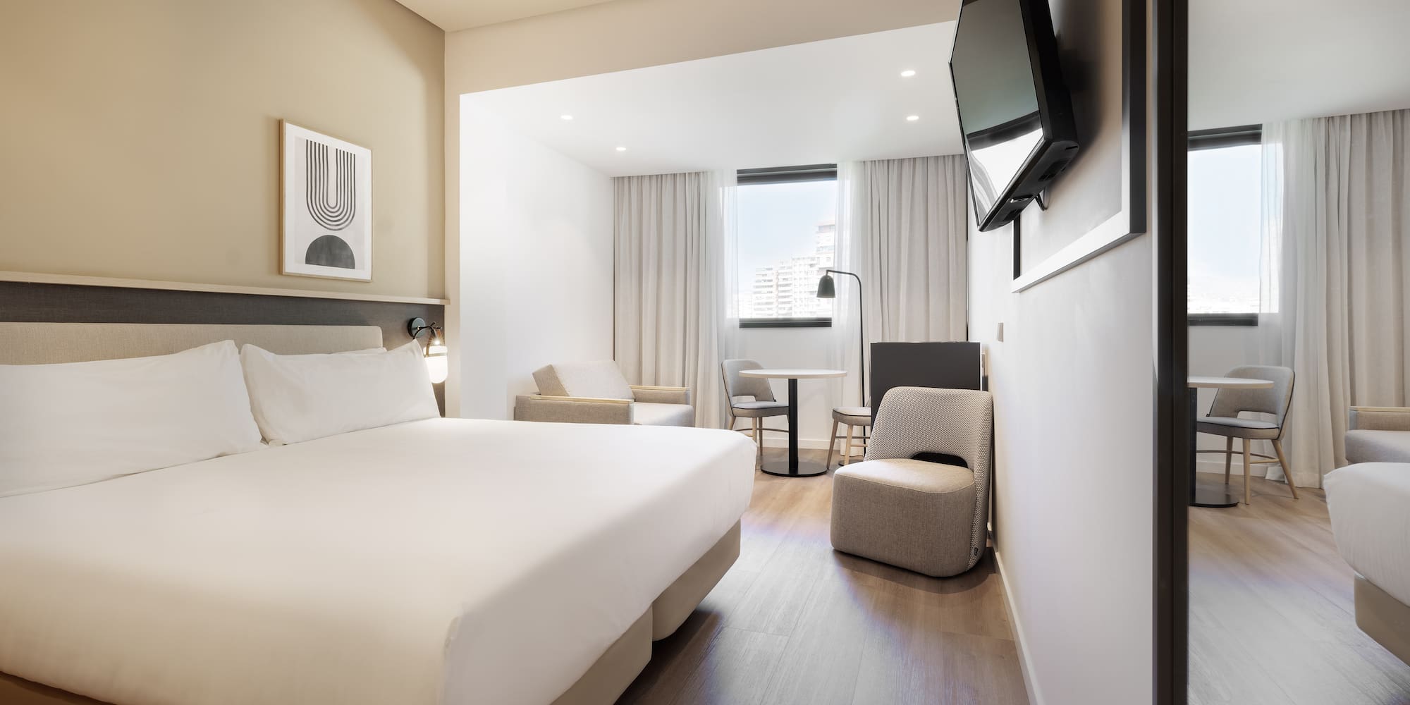 a room with a bed and a television