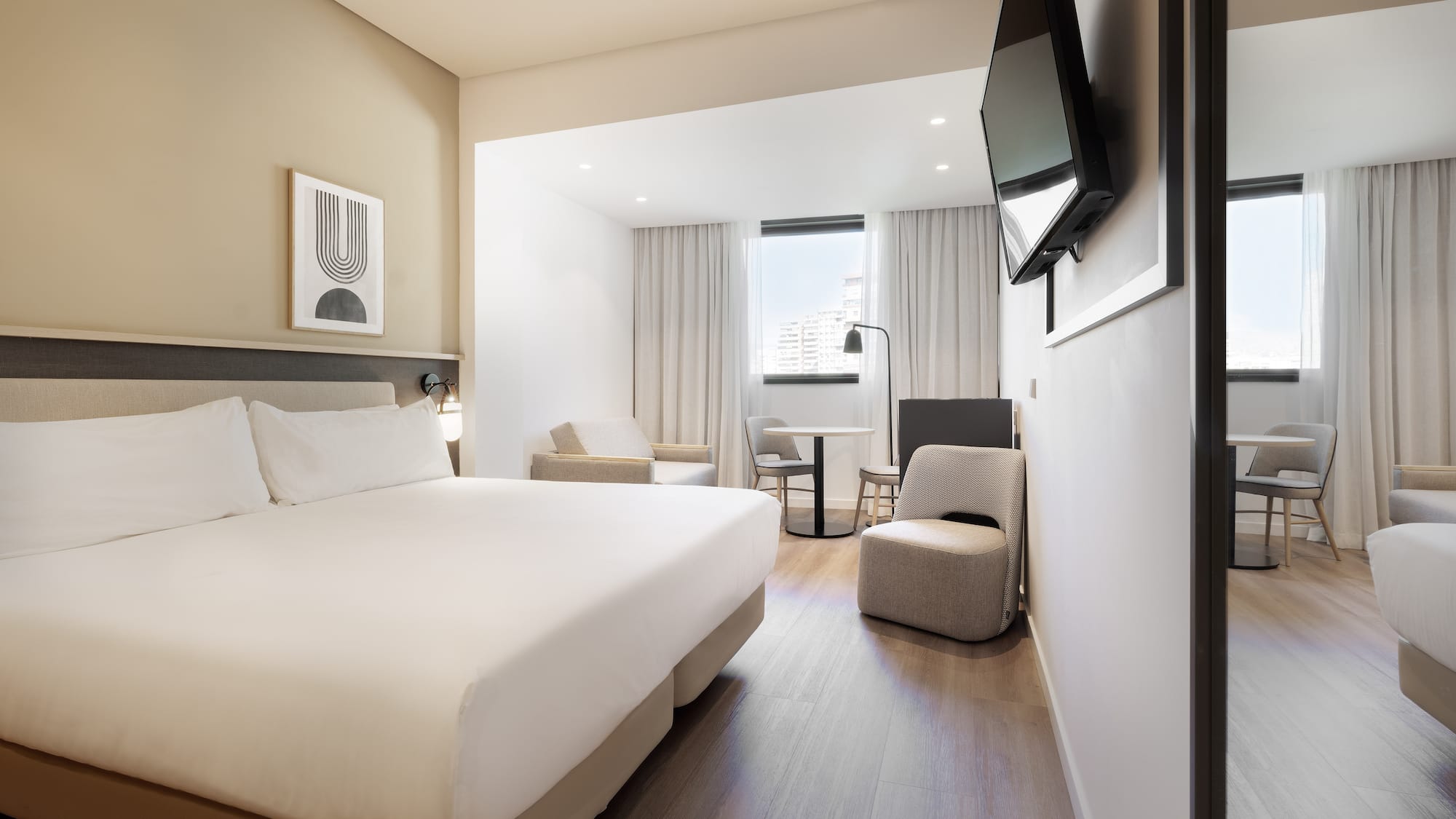 a room with a bed and a television