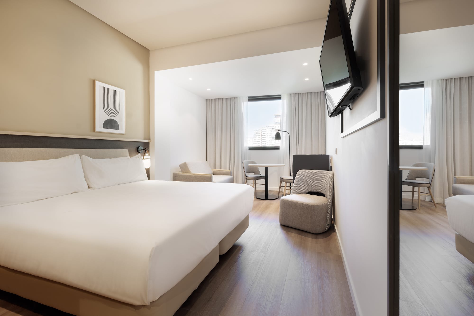 a room with a bed and a television