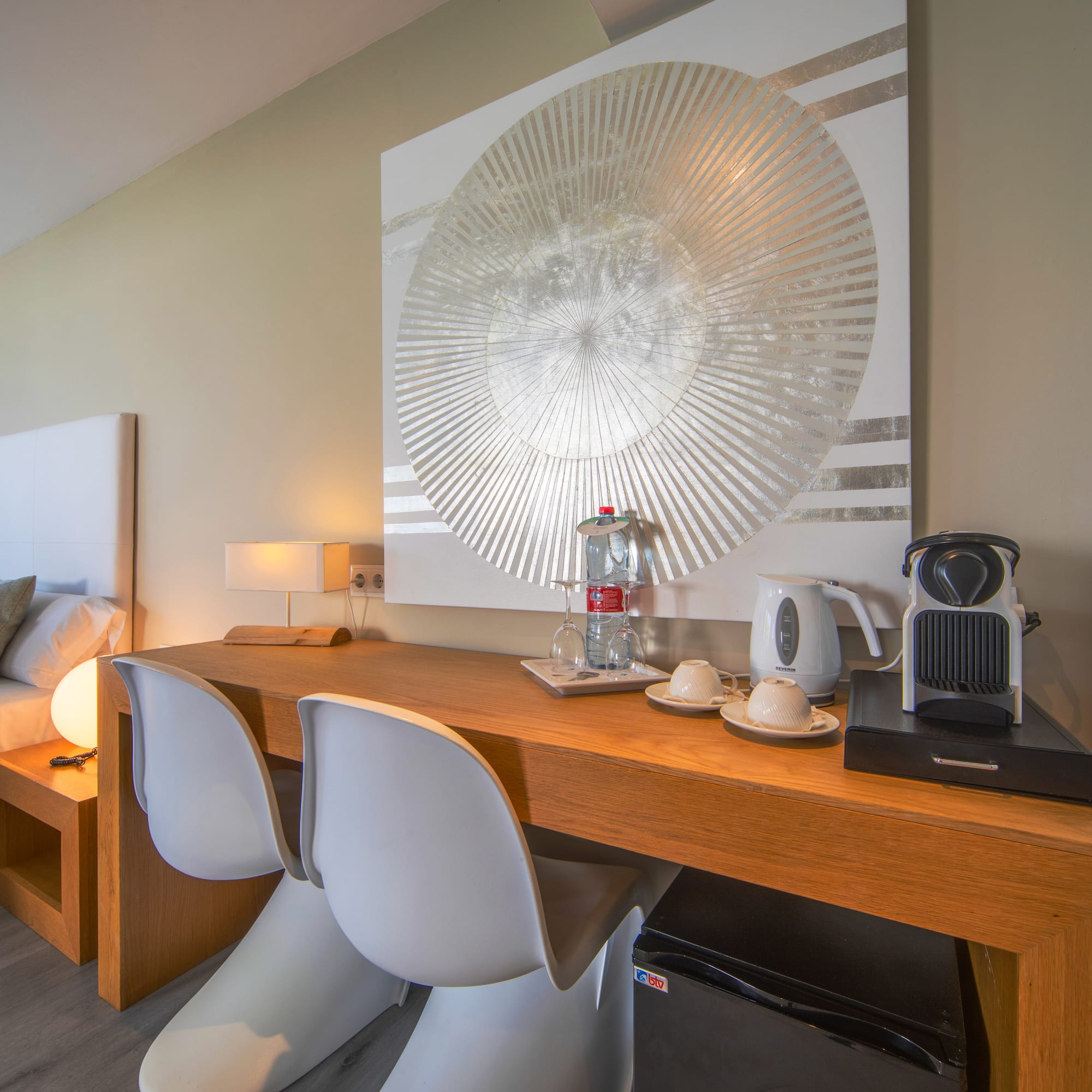a table with chairs and a coffee maker