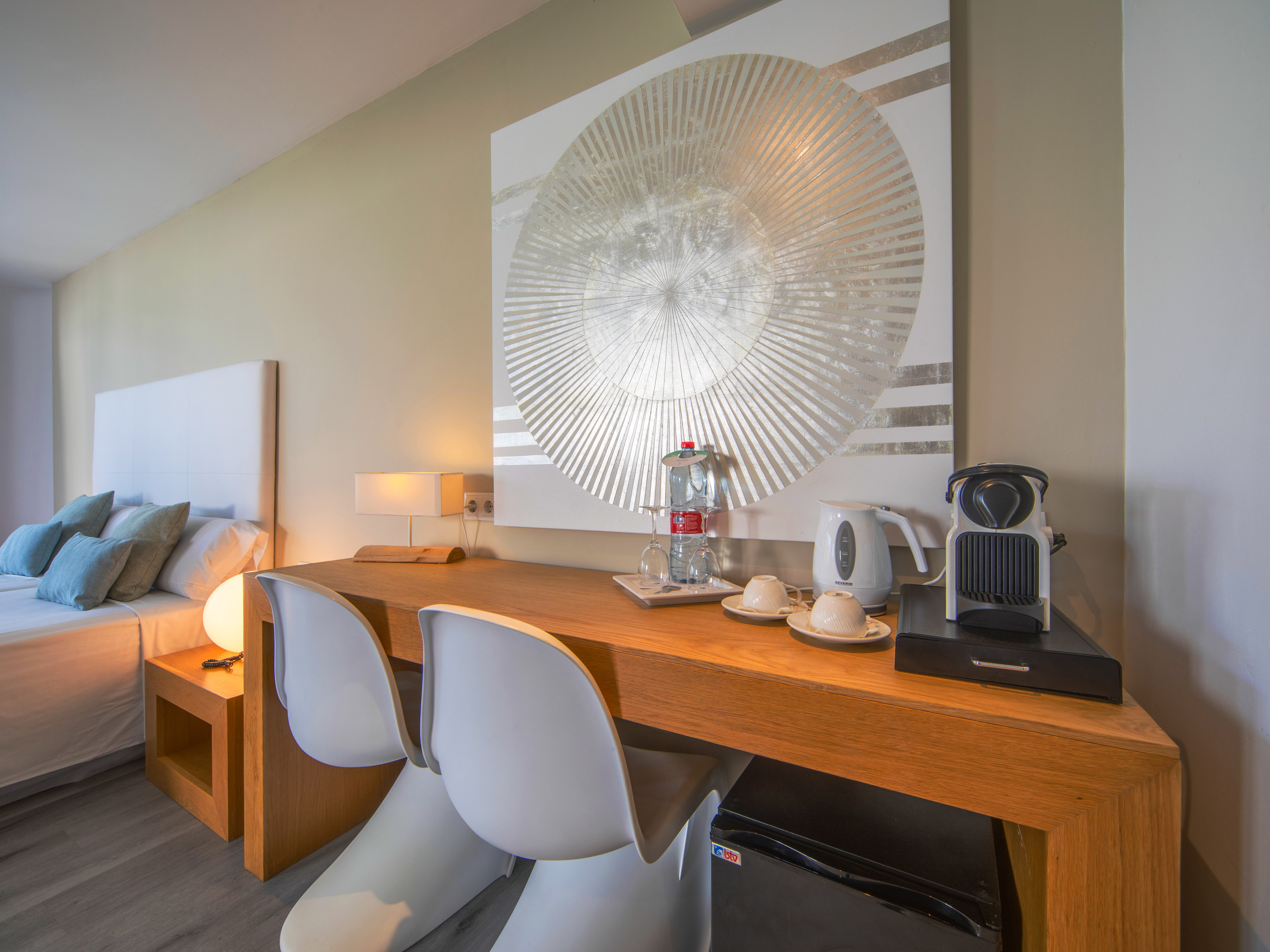 a table with chairs and a coffee maker