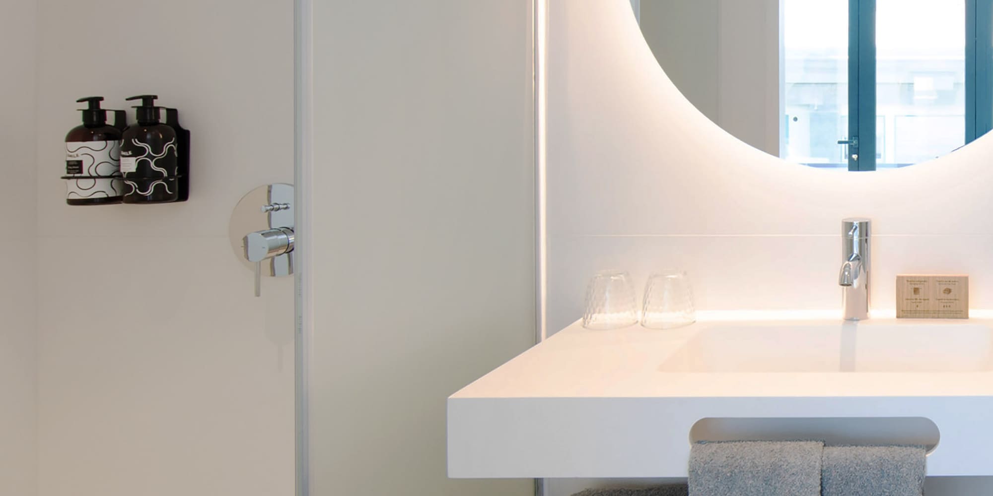 a bathroom with a round mirror