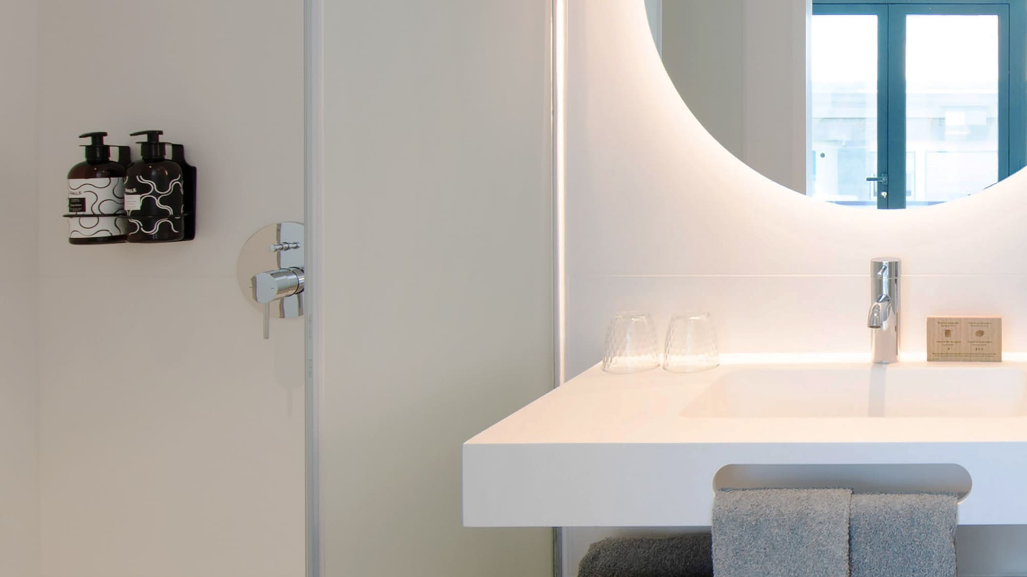 a bathroom with a round mirror