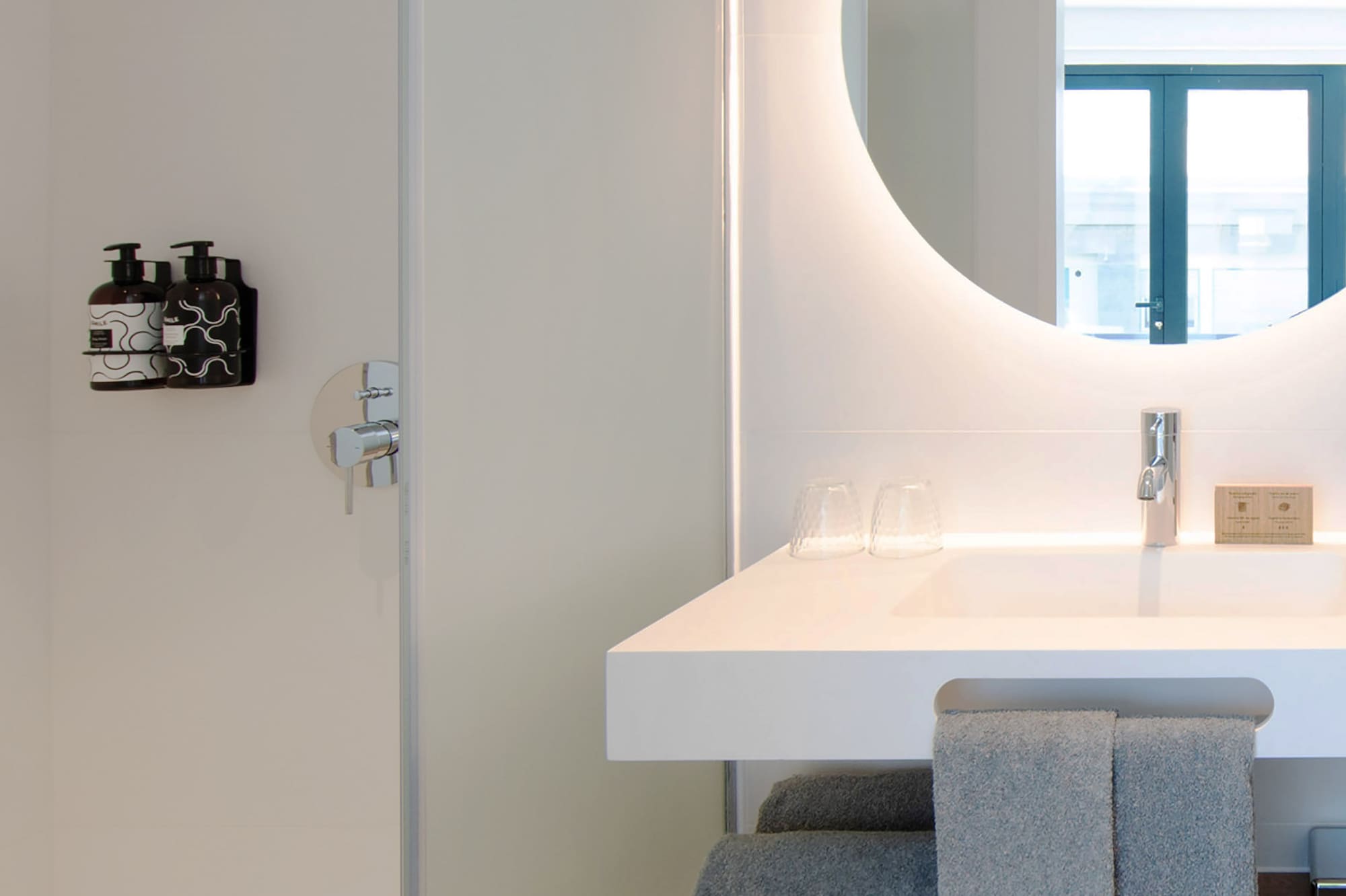 a bathroom with a round mirror