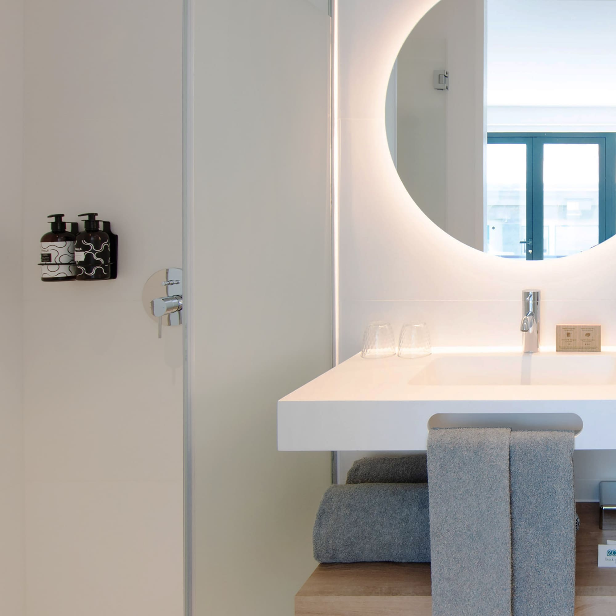 a bathroom with a round mirror