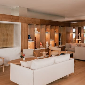 a room with a couch and chairs