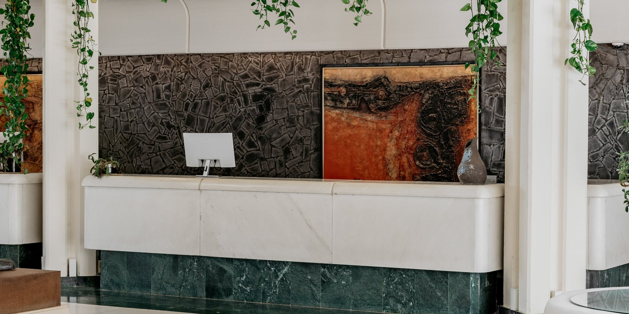 a white room with a white counter and a white couch