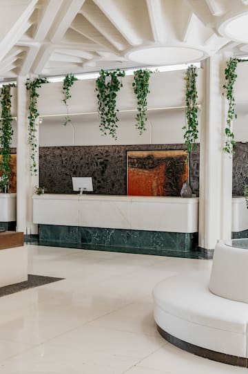 a white room with a white counter and a white couch