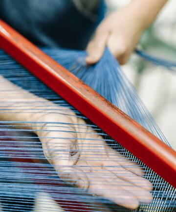 a person using a loom