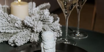 a candle and wine glasses on a table