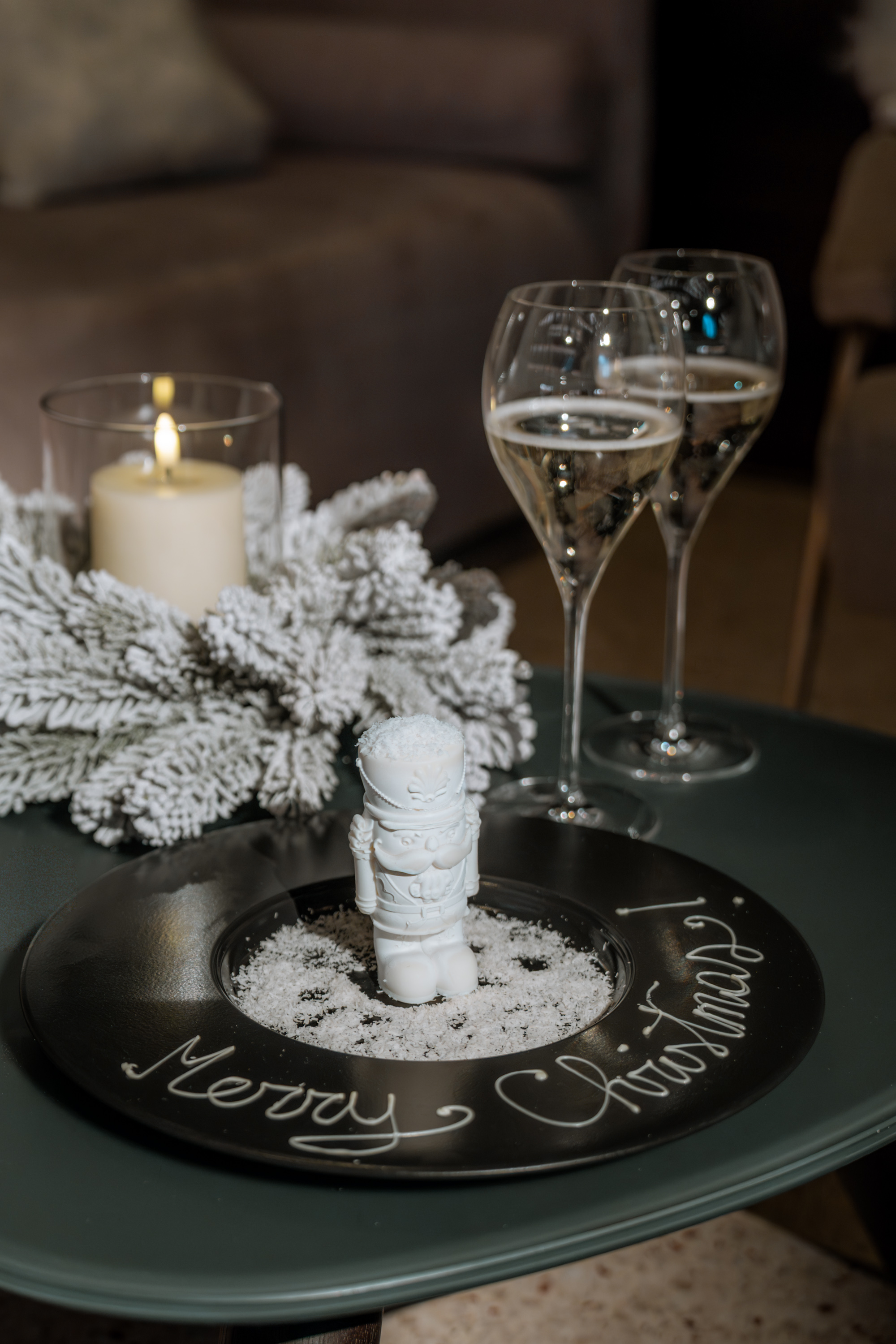 a candle and wine glasses on a table