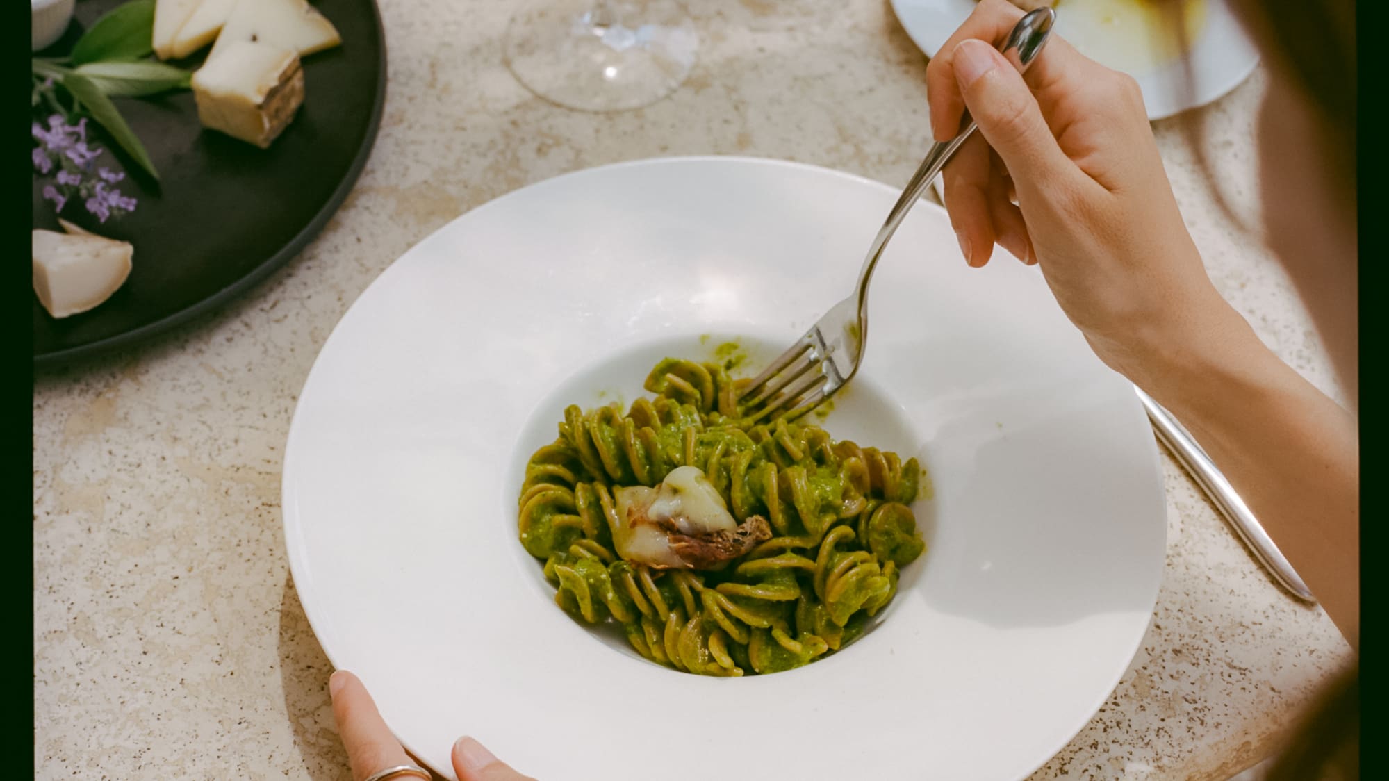 a person eating pasta with a fork