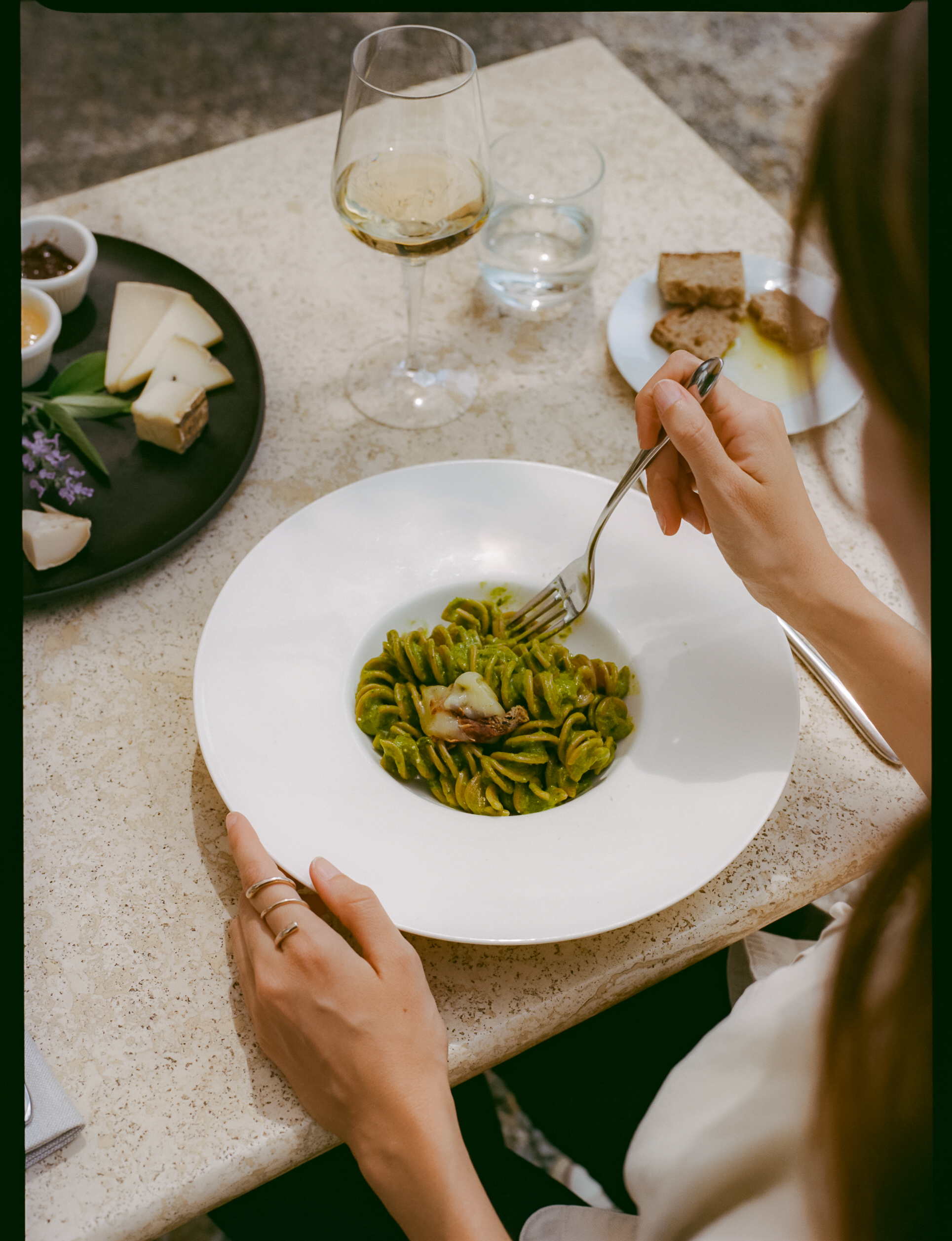 a person eating pasta with a fork