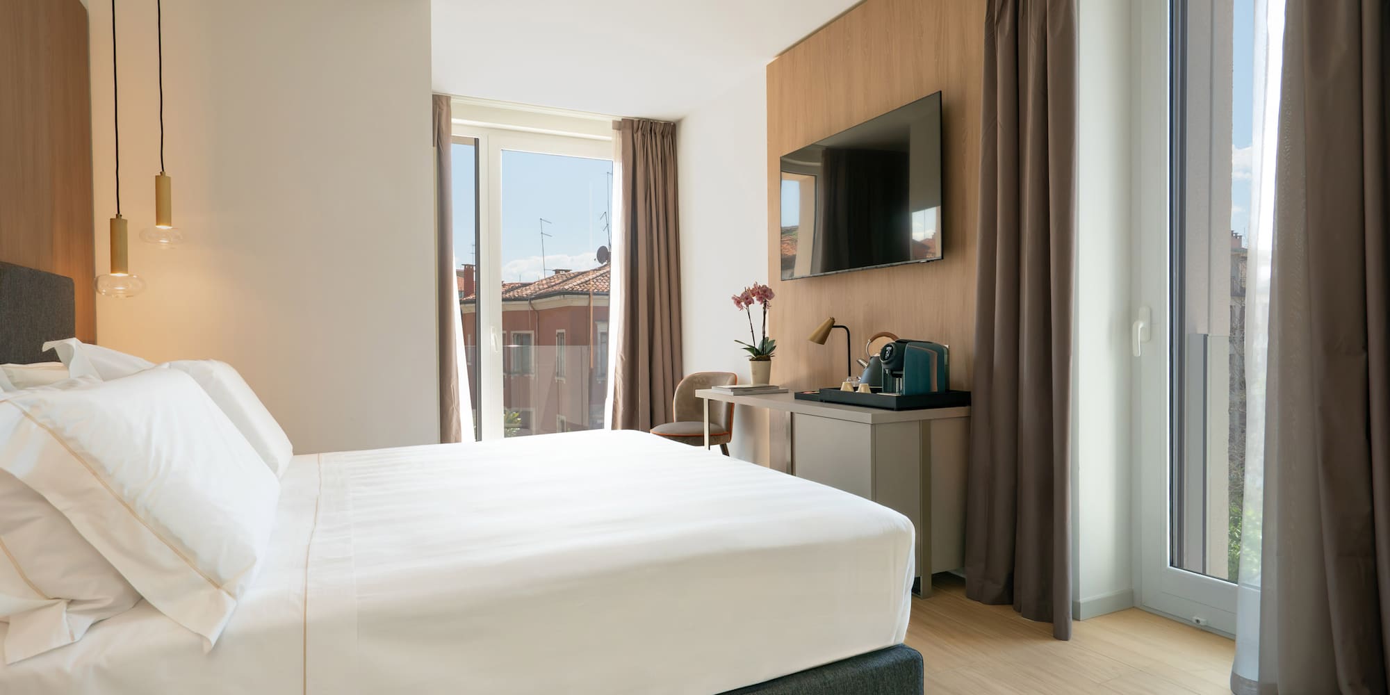 a bedroom with a bed and a television