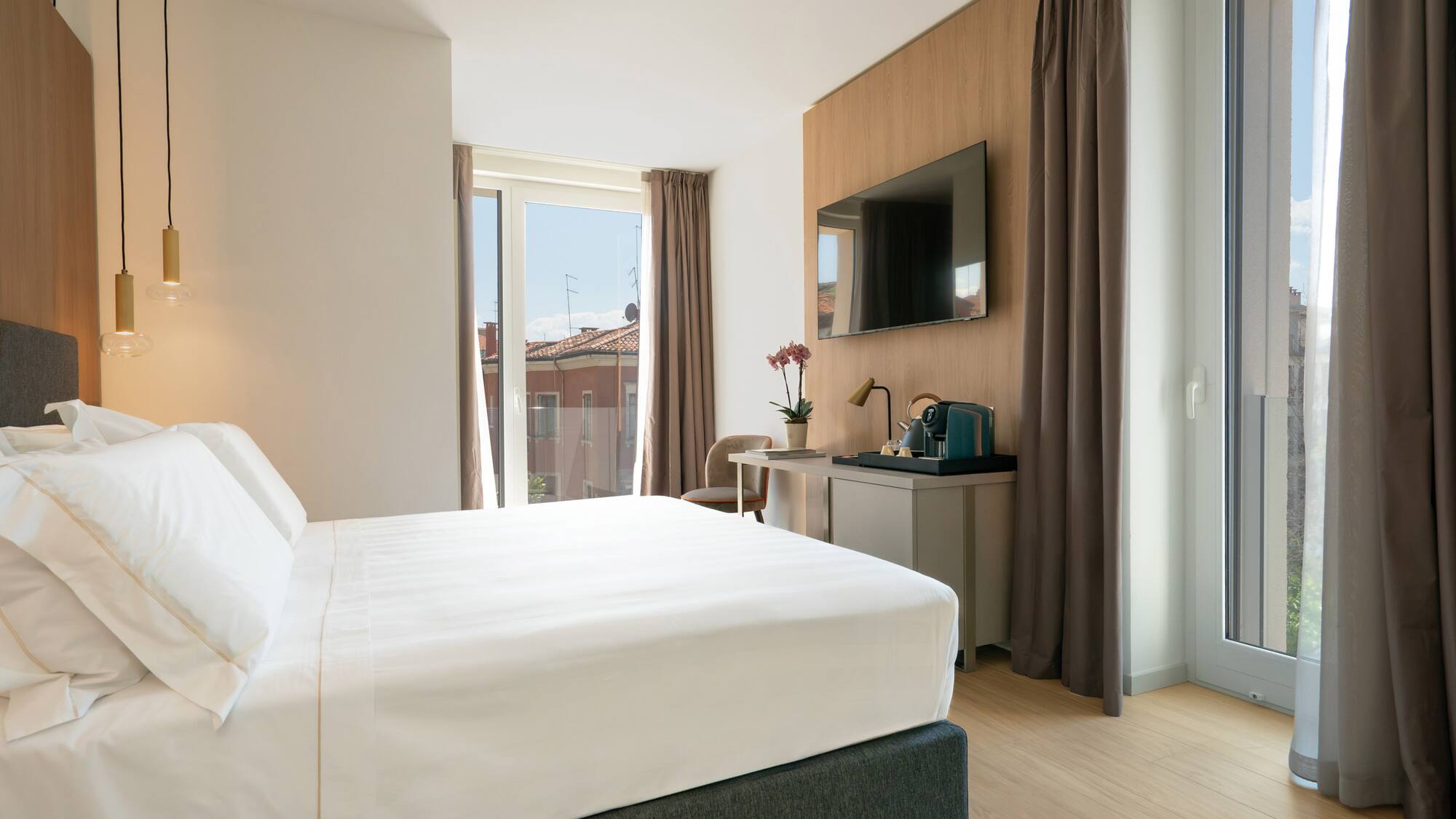 a bedroom with a bed and a television