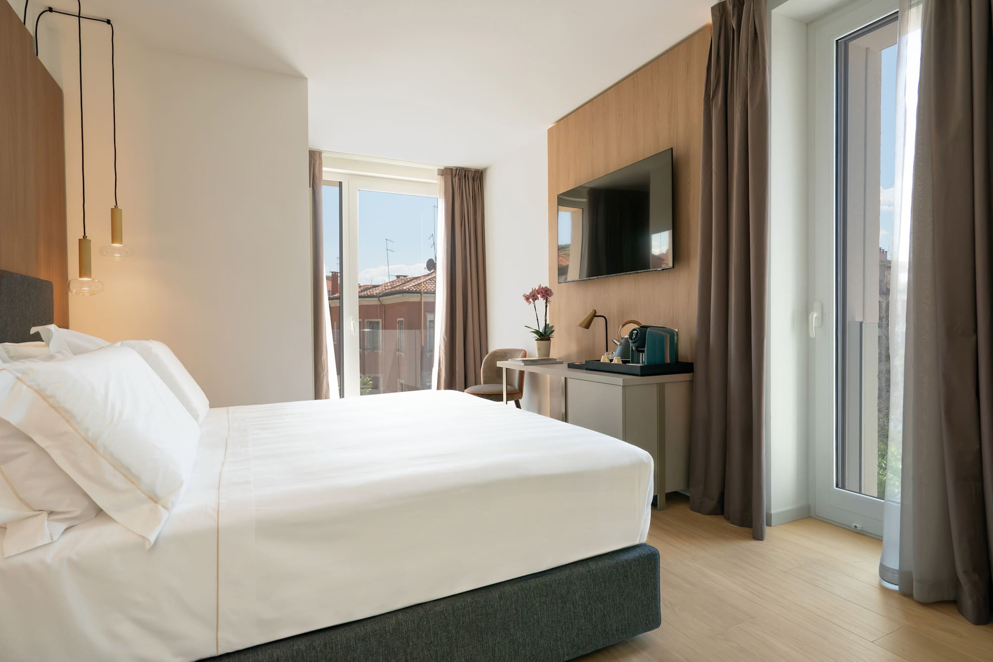 a bedroom with a bed and a television