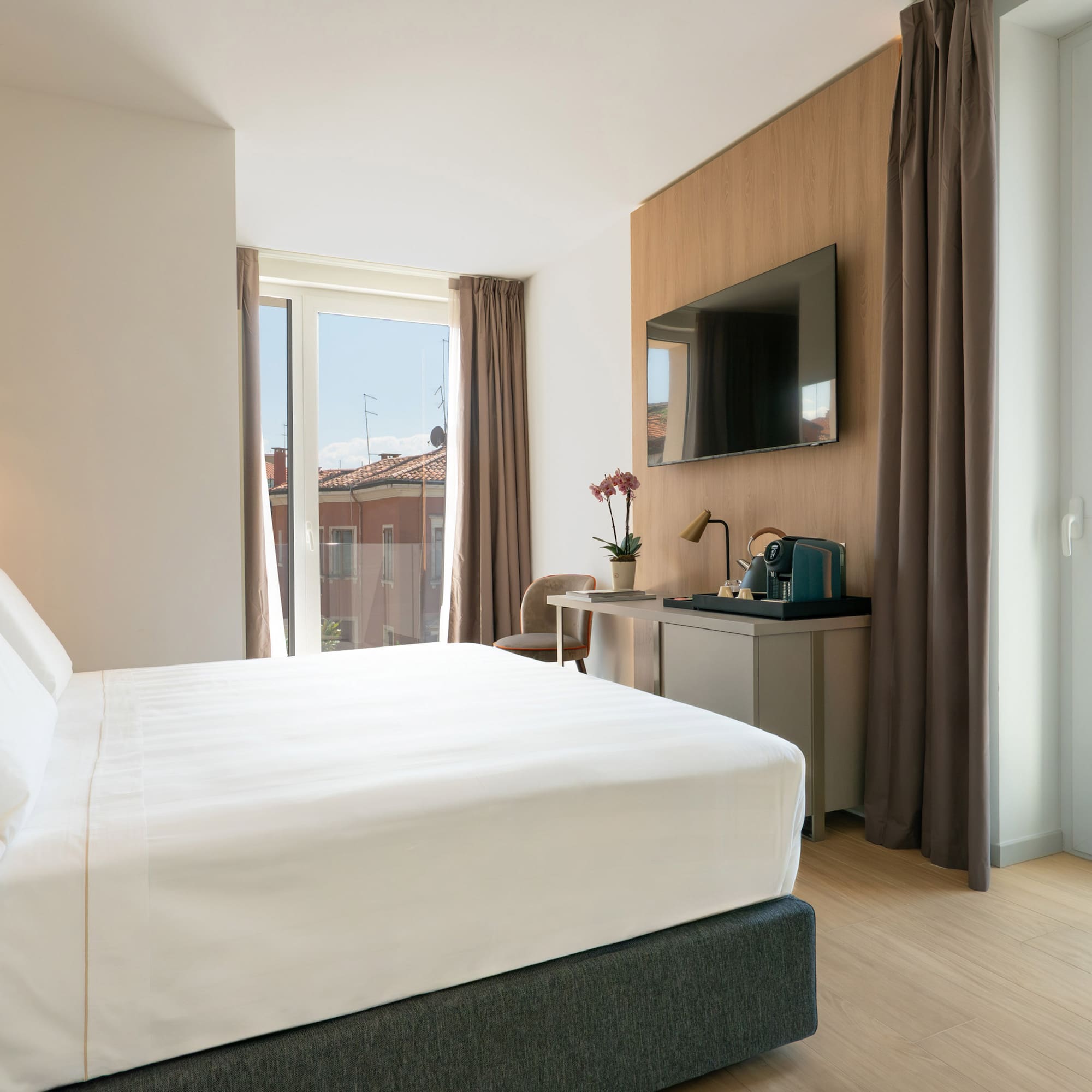 a bedroom with a bed and a television