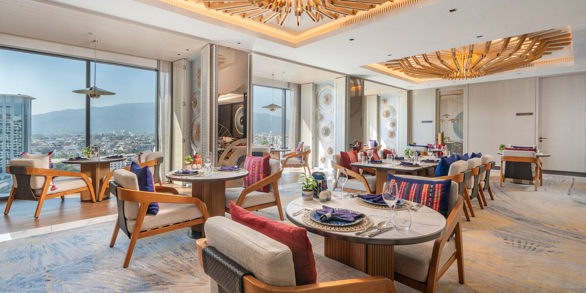 Modern luxury restaurant with city view, unique wooden ceiling, and elegant tables.