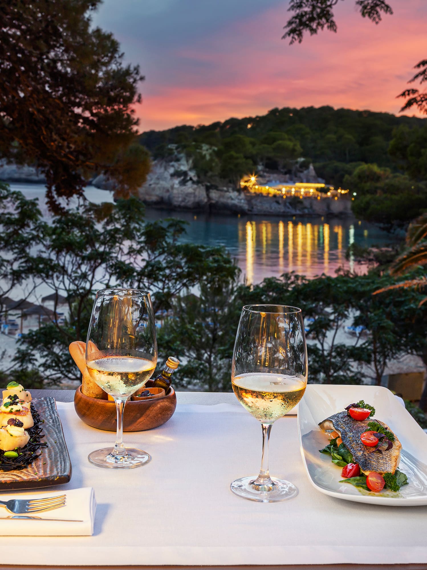 a table with food and wine glasses on it