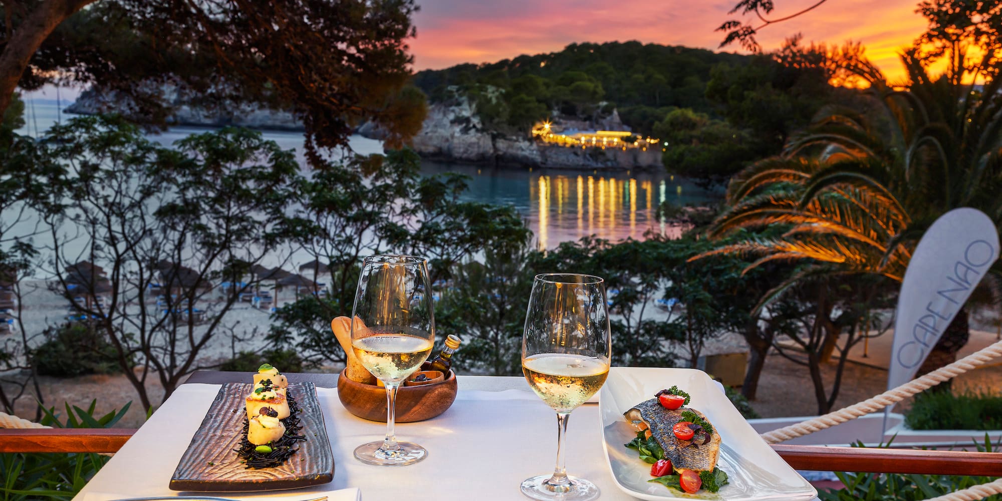 a table with food and wine glasses on it