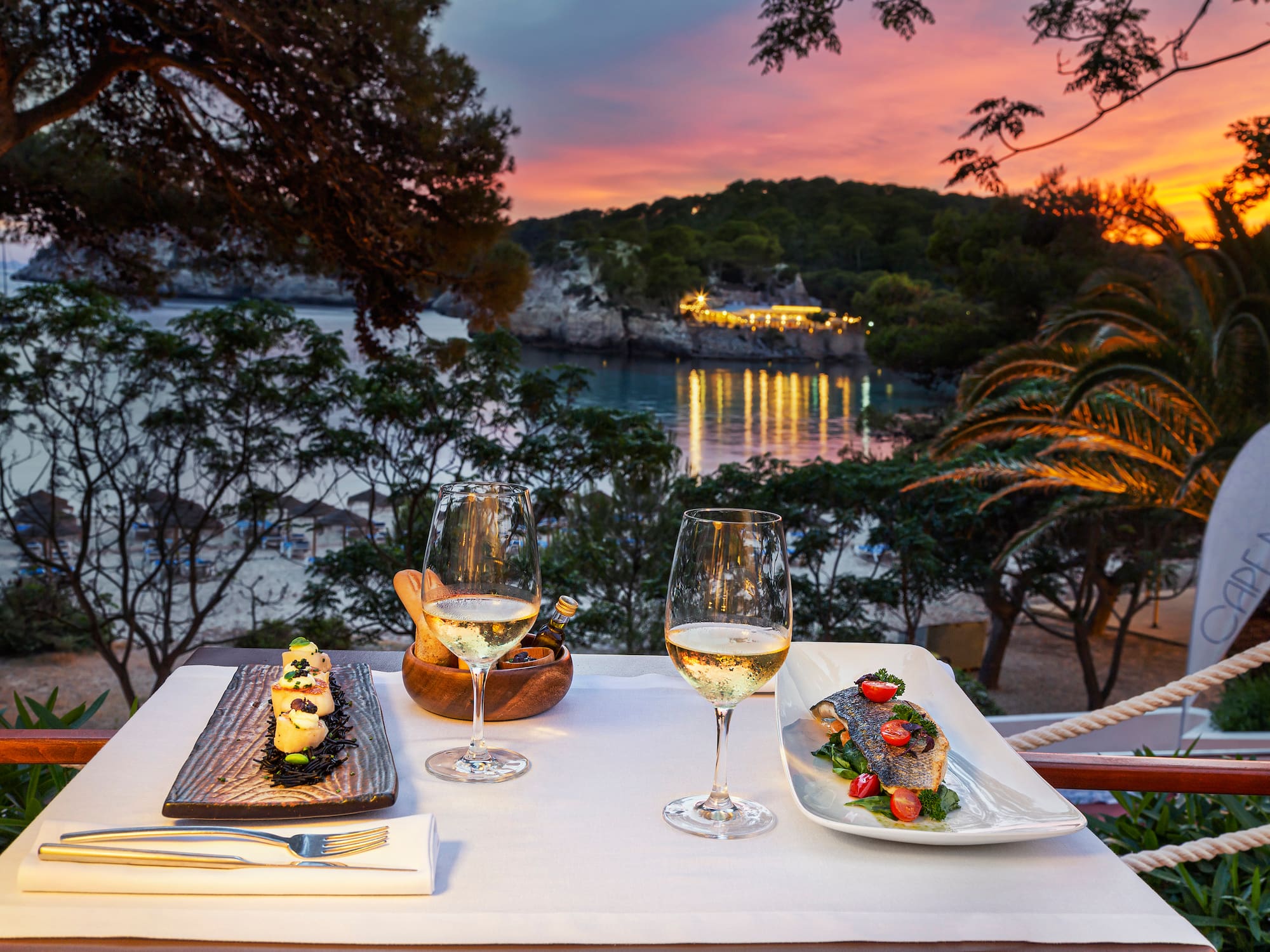 a table with food and wine glasses on it.