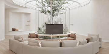 a room with a round table and a television