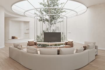 a room with a round table and a television